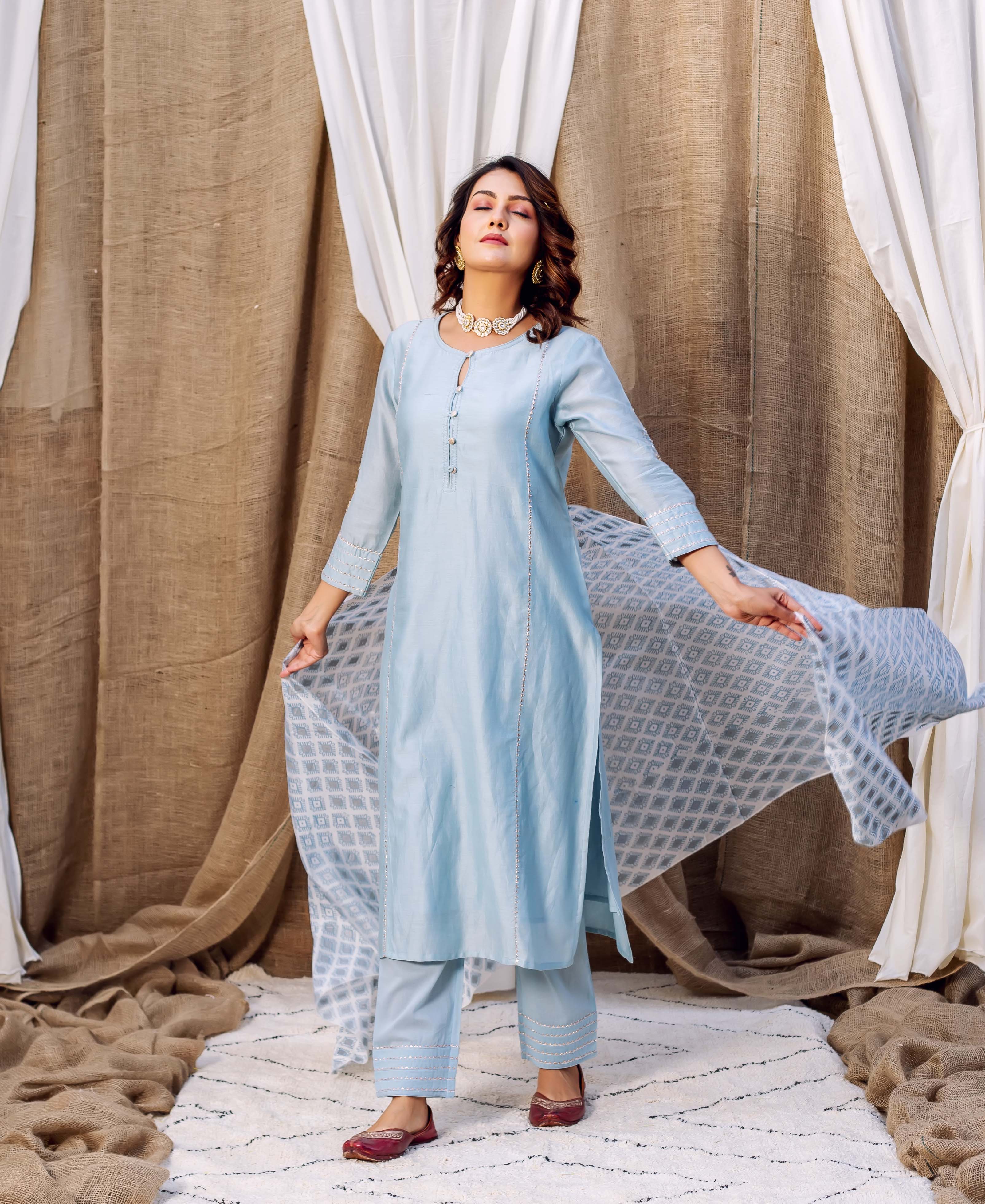 Light blue silk kurta with white hand-block print and gold accents on cuffs and hem.