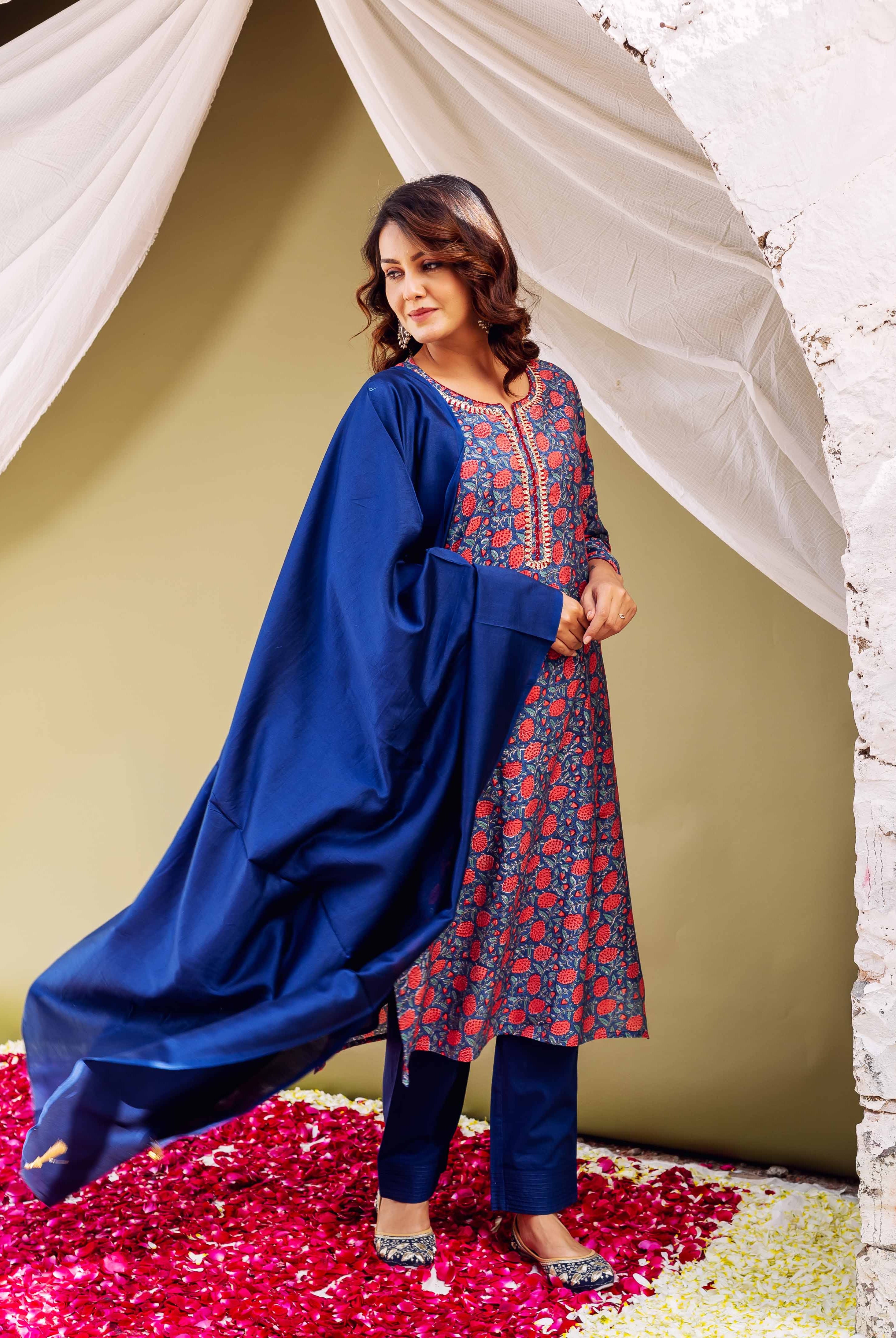 Model in blue hand-block-printed kurta with red floral print, matching pants, and dupatta.
