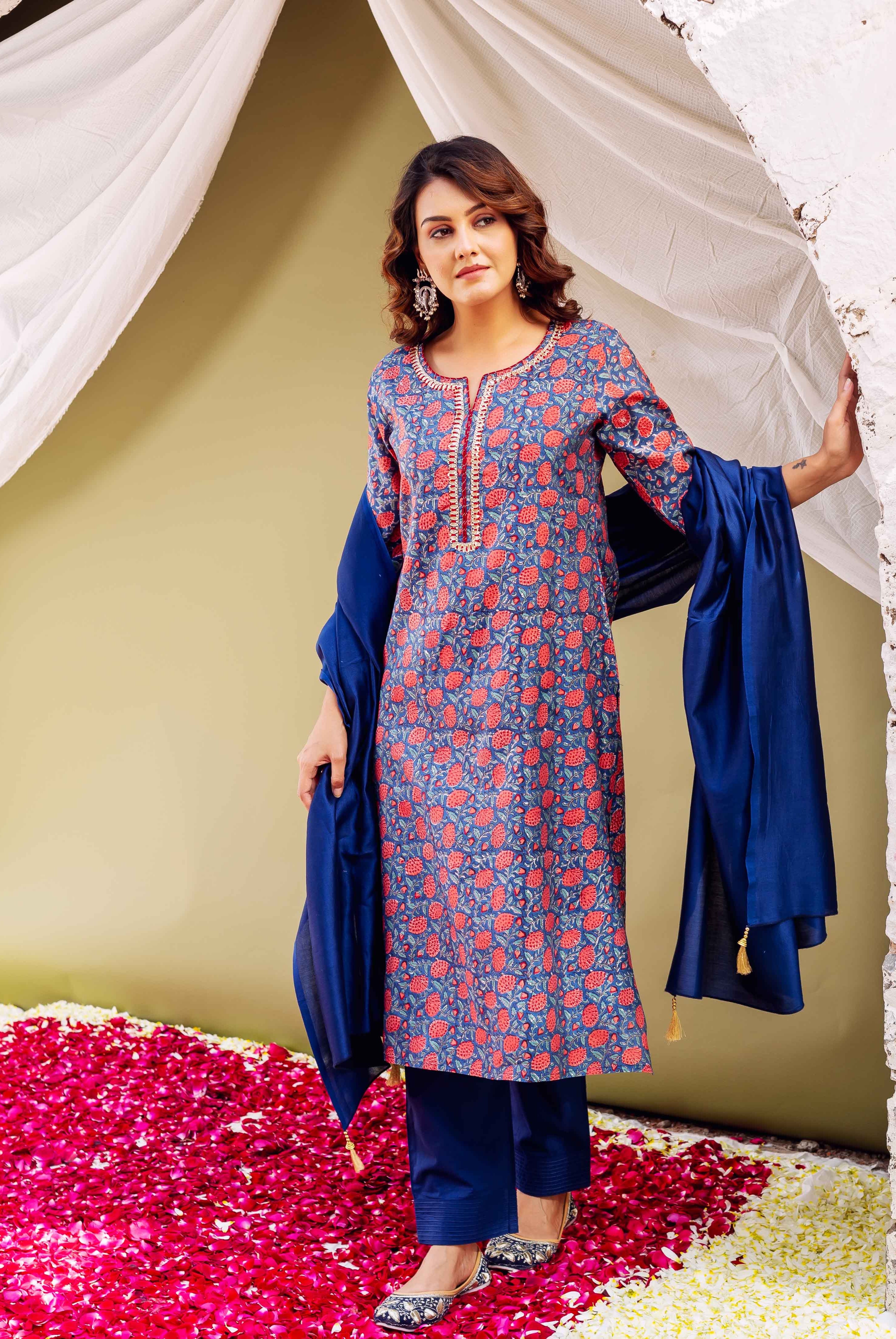 Front view of model wearing blue hand-block printed kurta set with red floral print.