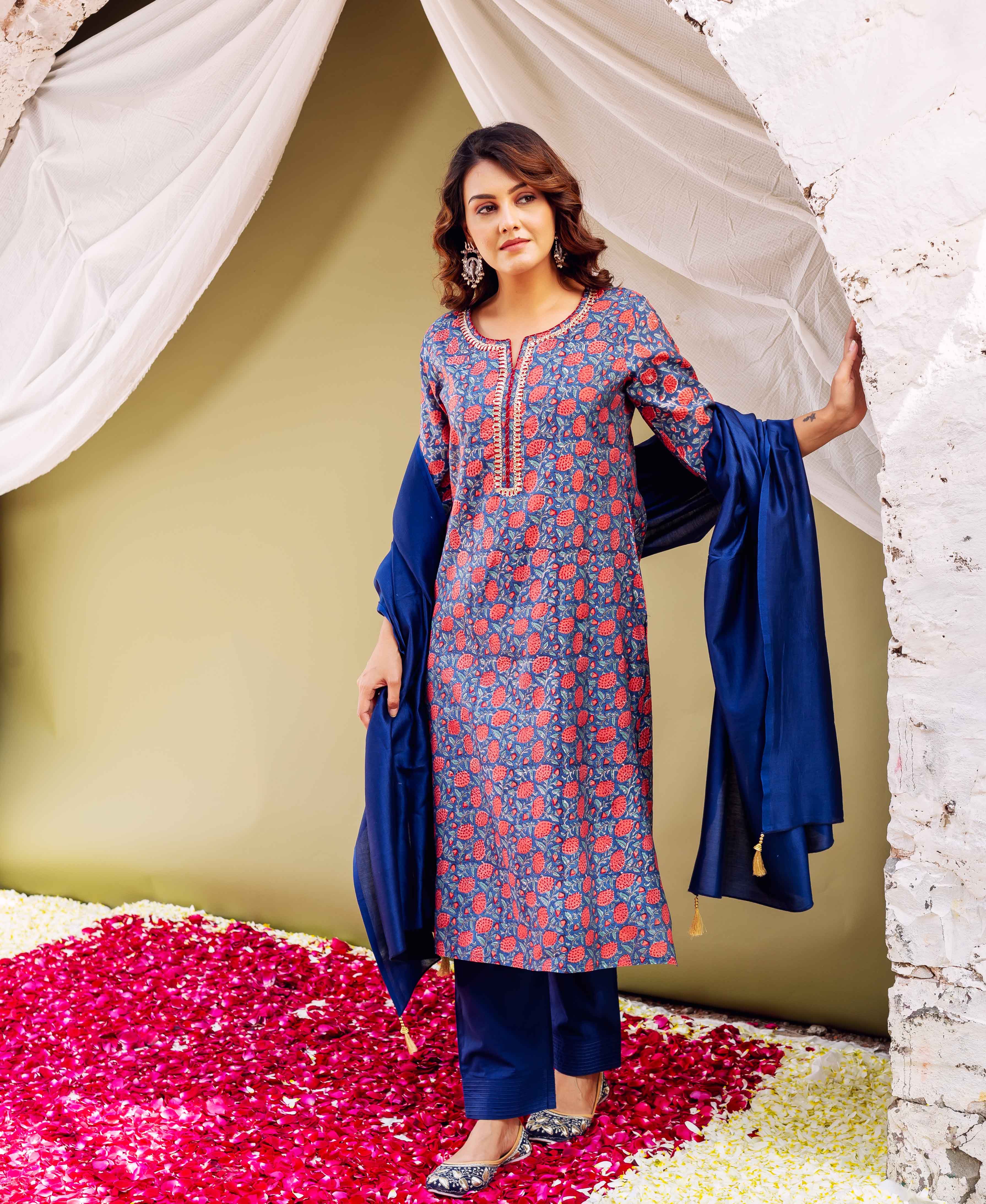 Front view of model wearing blue hand-block printed kurta set with red floral print.
