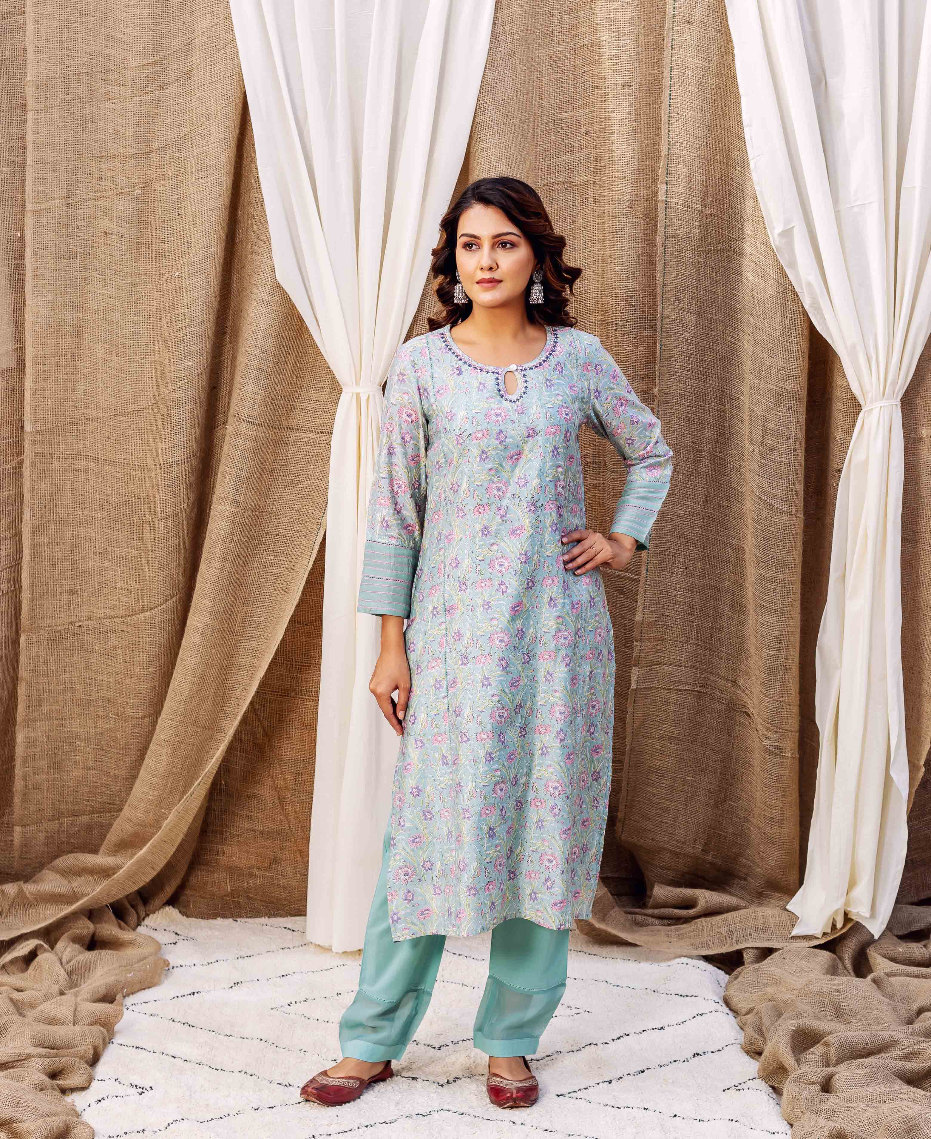 Front full look of model wearing a sea green hand-block-printed floral kurta set.