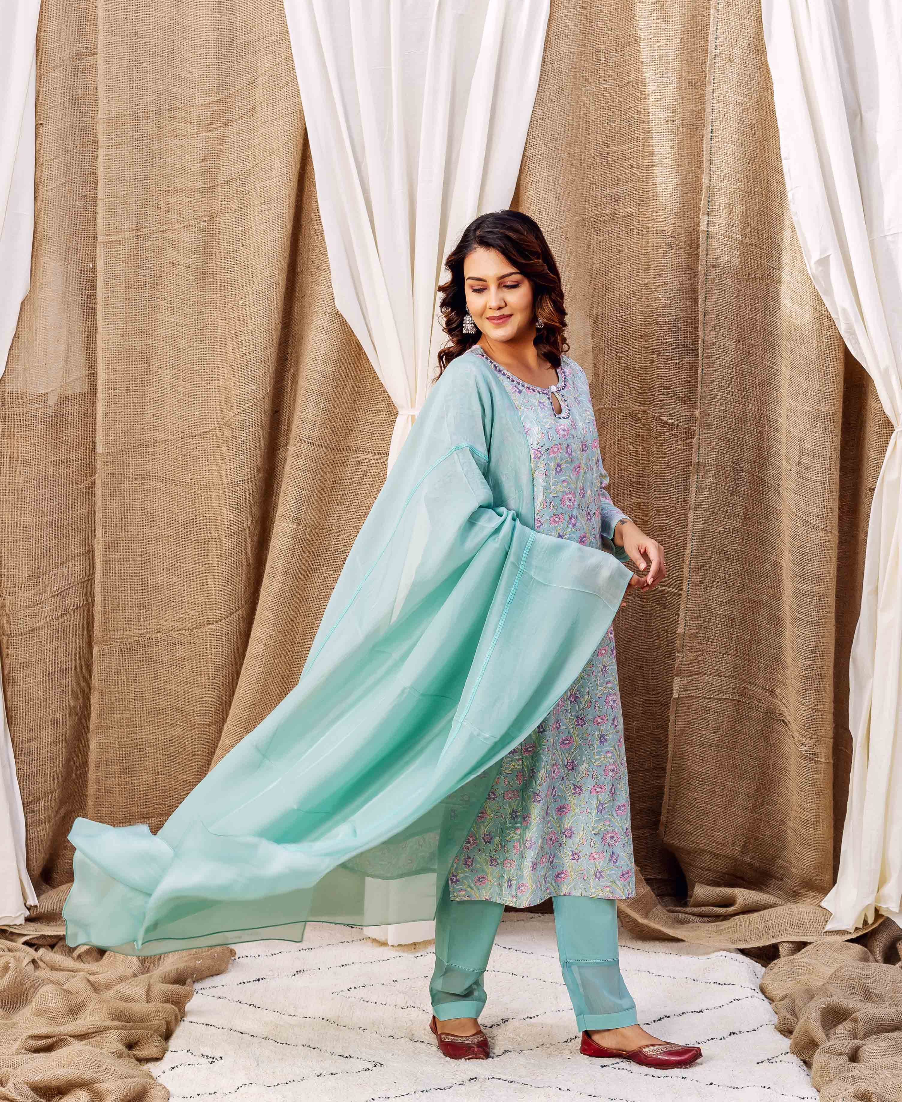 Full-length front view of a model in a sea green floral hand-printed kurta set.