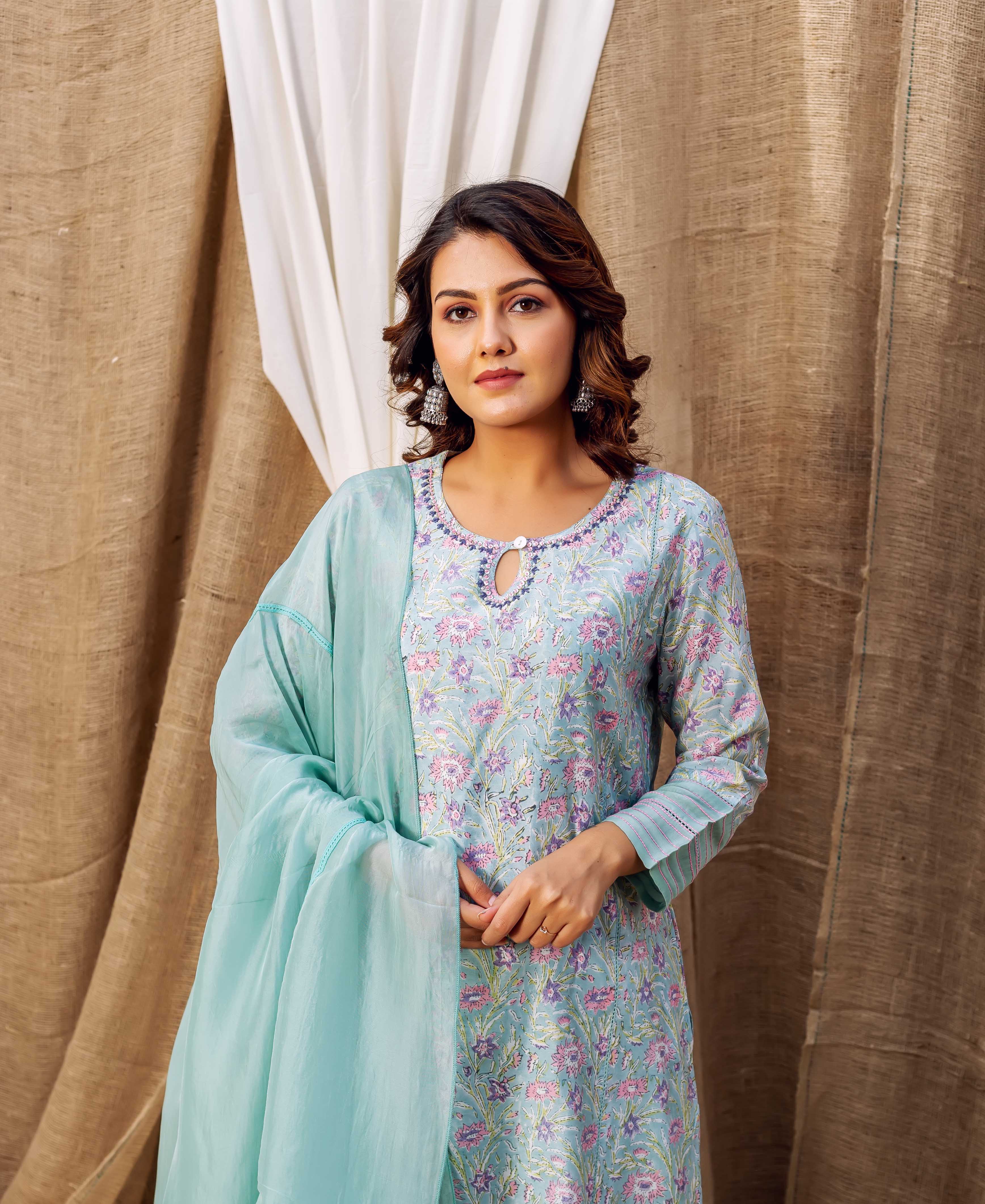 Front view of model in a sea green hand-printed floral kurta with matching dupatta.