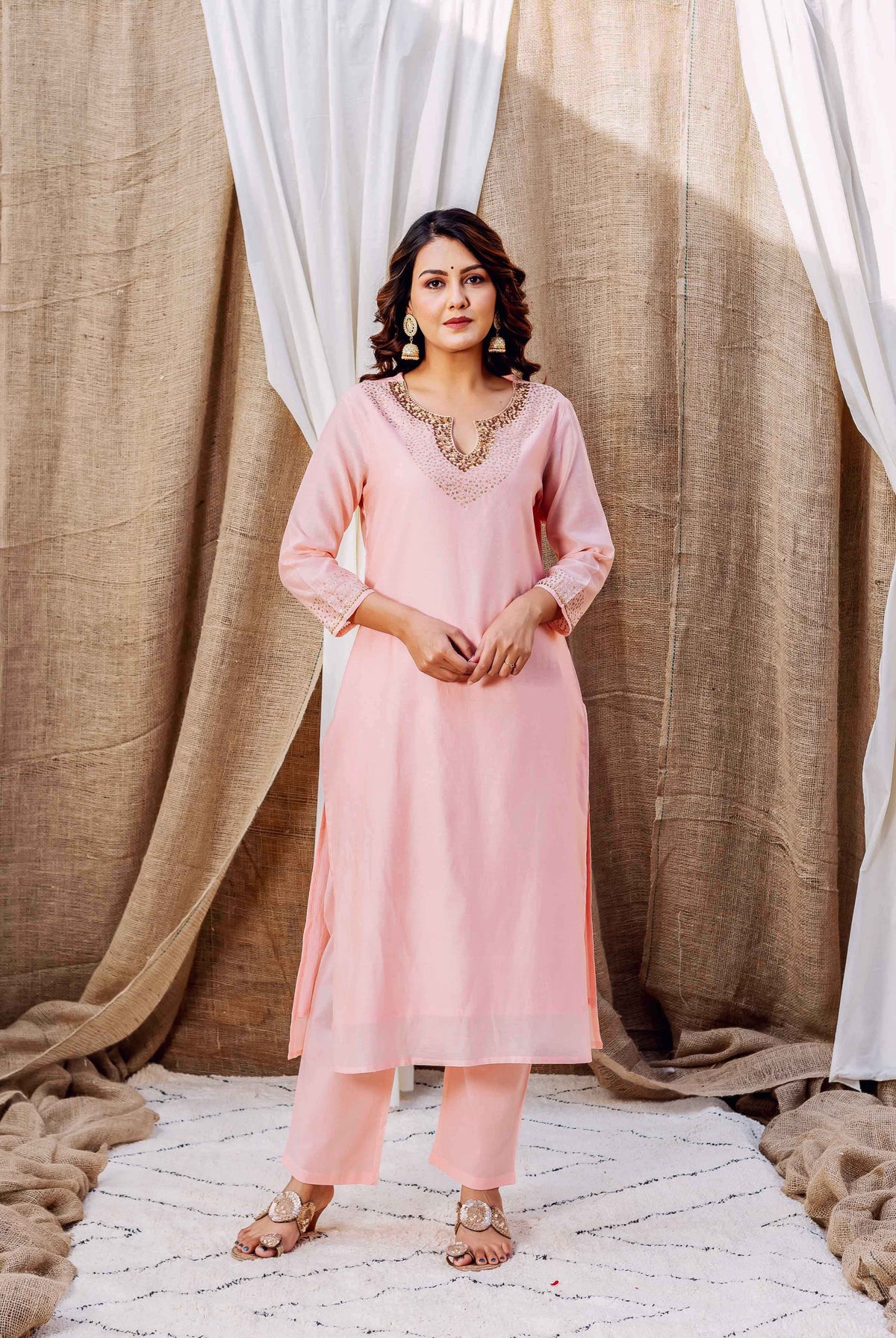 Full-length model shot of a rose Chanderi kurta set with intricate gold embroidered neckline.