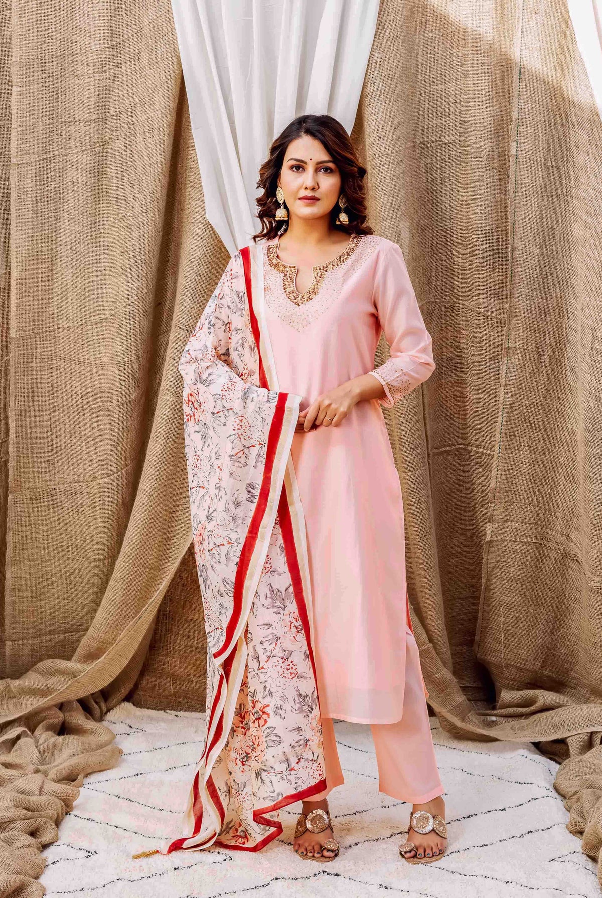 Model wearing light pink chanderi kurta set with embroidered neckline and floral hand-block printed dupatta.