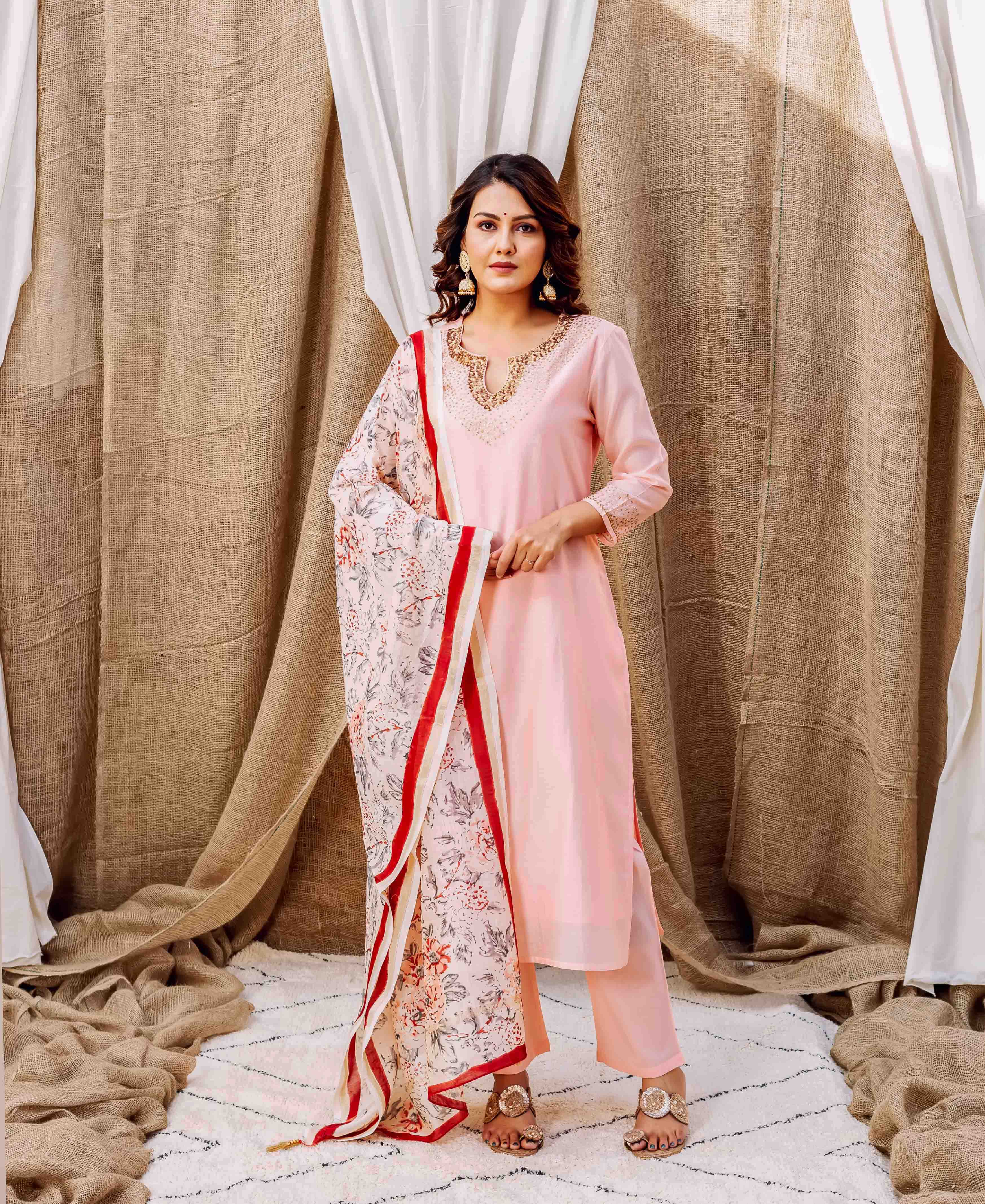 Model wearing light pink chanderi kurta set with embroidered neckline and floral hand-block printed dupatta.