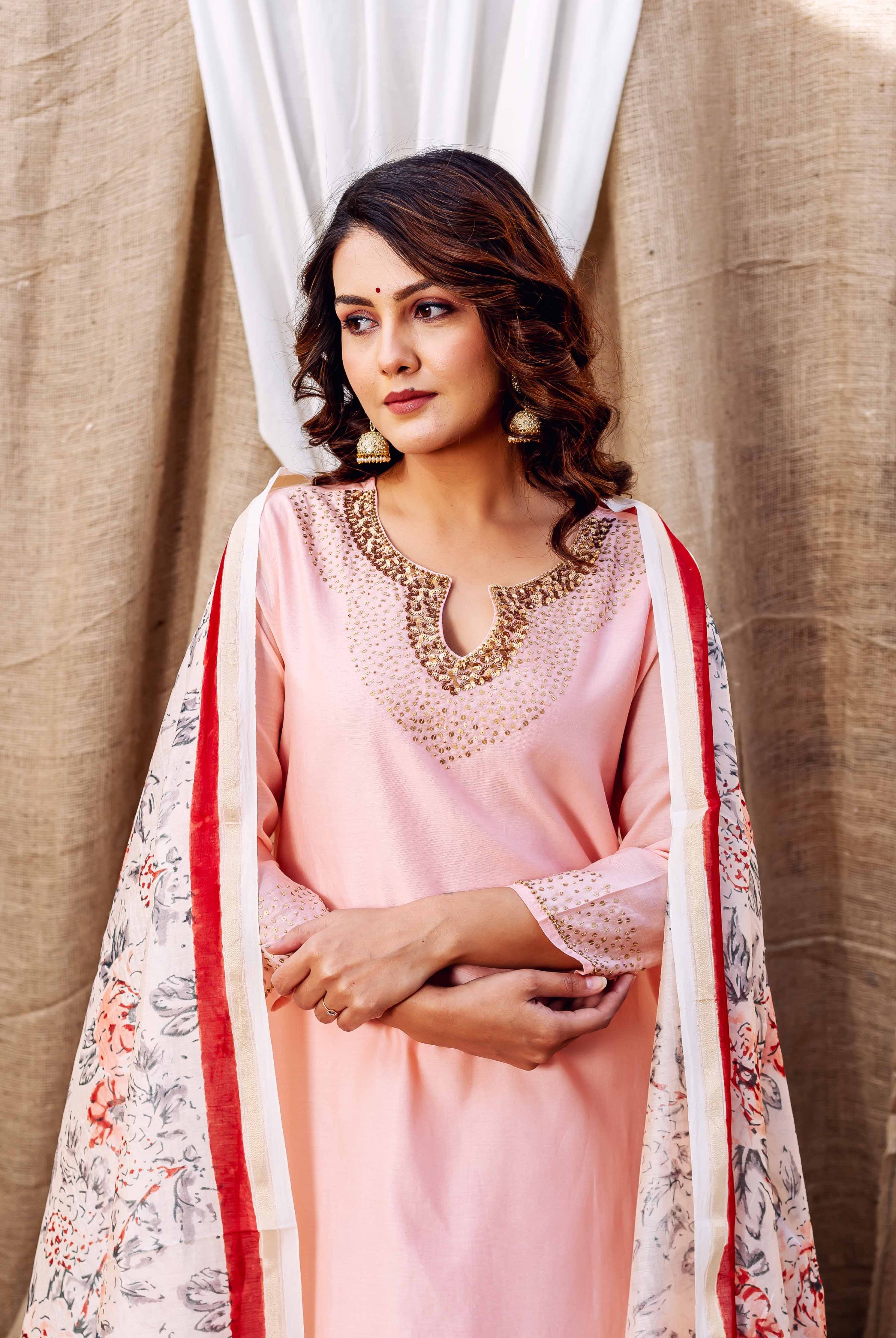 Woman in rose pink Chanderi kurta with embellished neckline and floral printed dupatta.