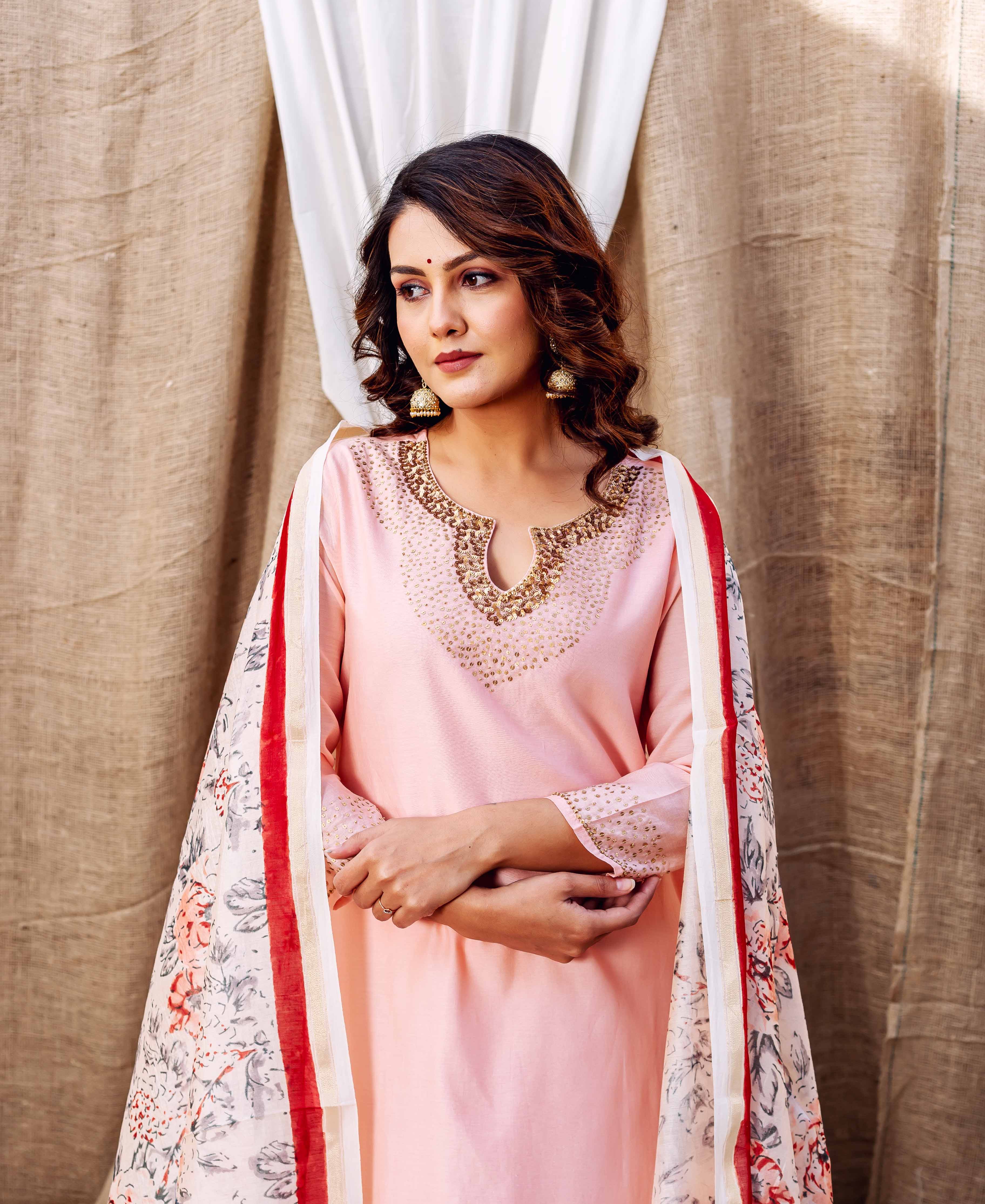 Woman in rose pink Chanderi kurta with embellished neckline and floral printed dupatta.