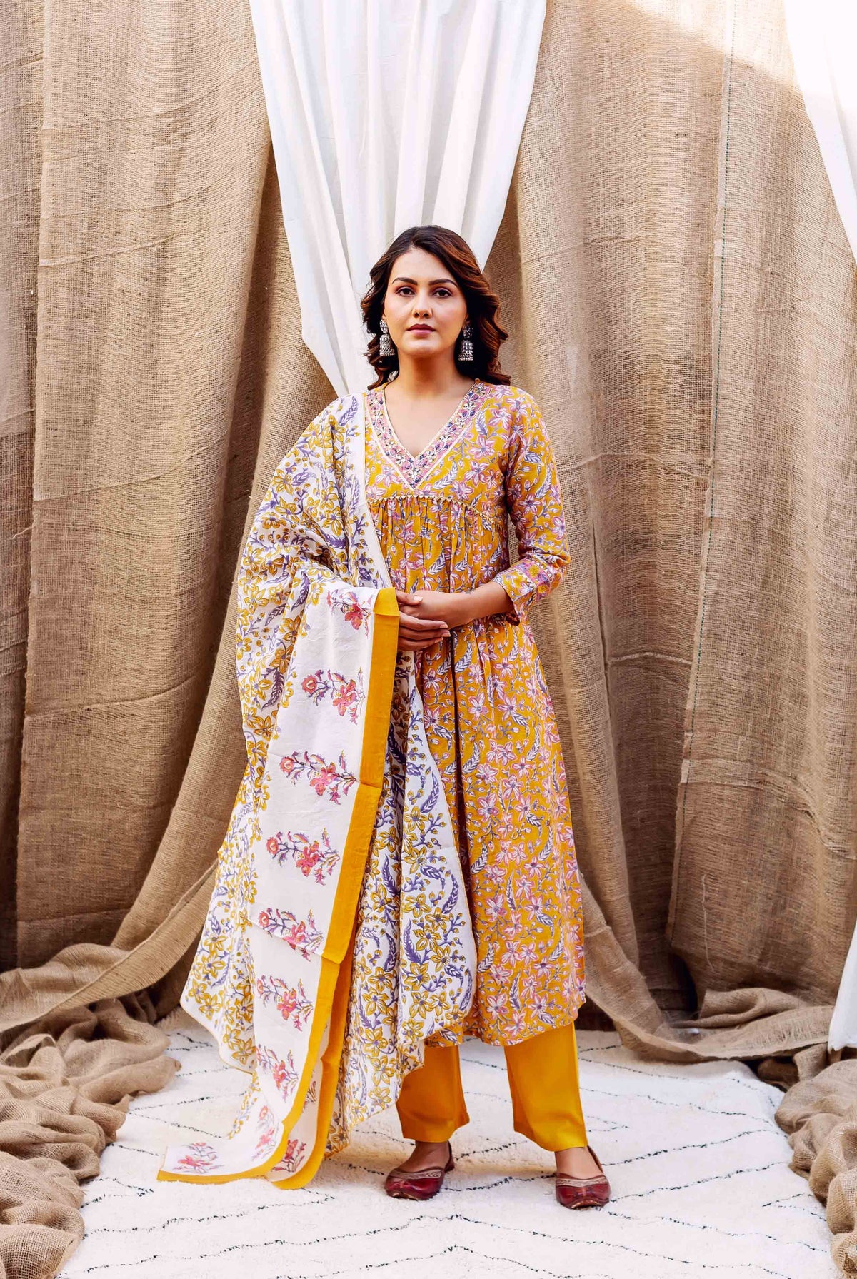 A model wearing a yellow floral block-printed kurta with a matching dupatta.