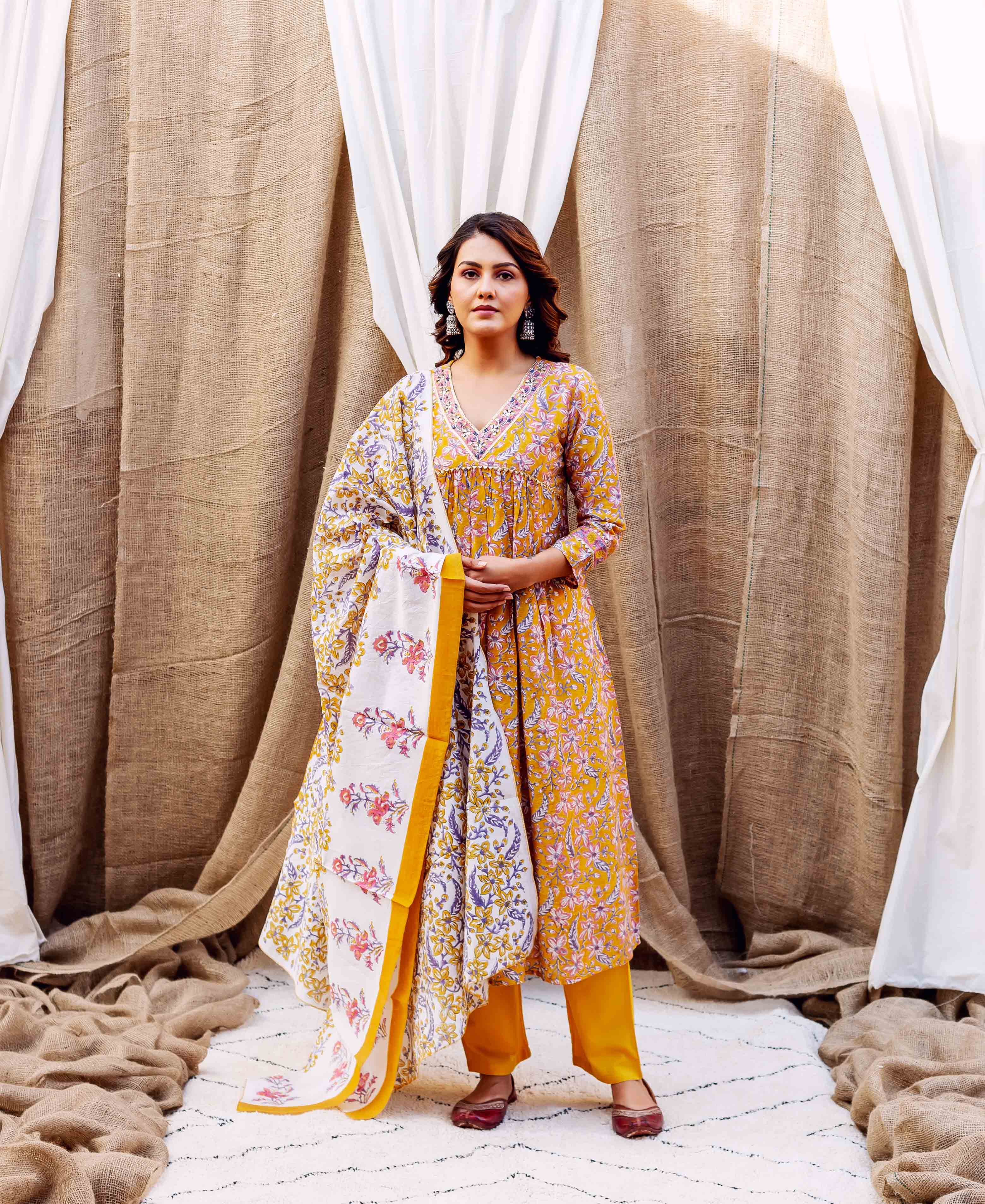 A model wearing a yellow floral block-printed kurta with a matching dupatta.