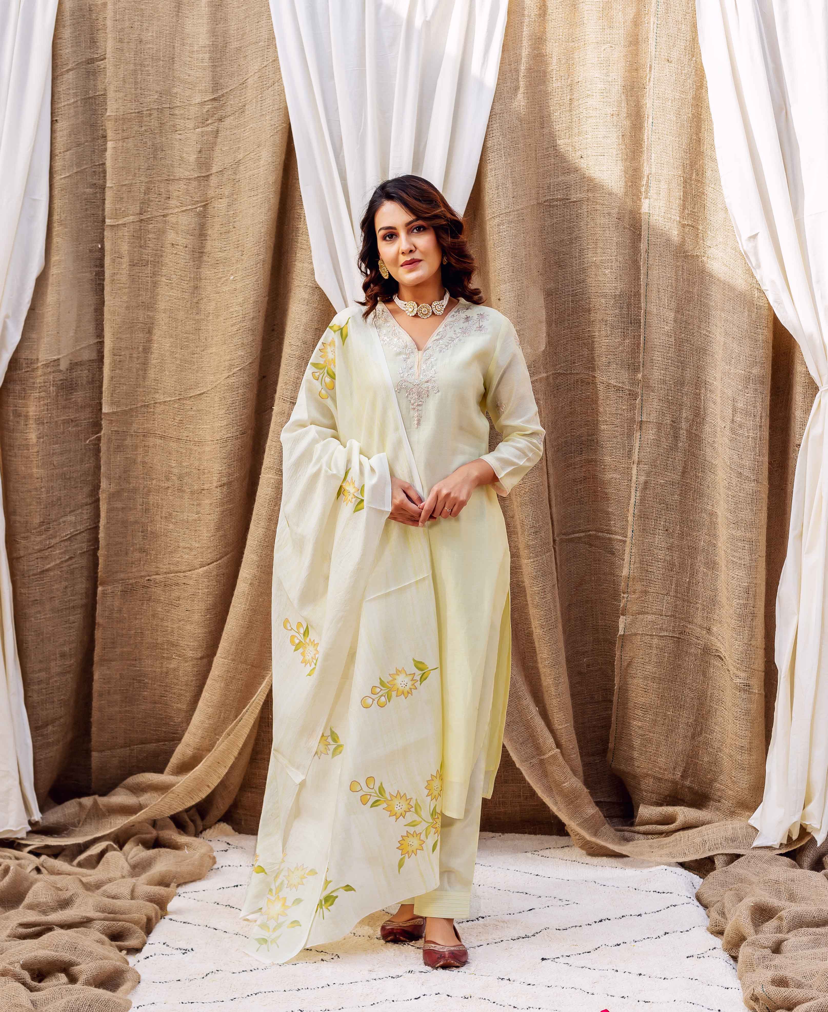 Full-length model in pale yellow kurta set, draped with hand-block-printed yellow floral chanderi silk dupatta.