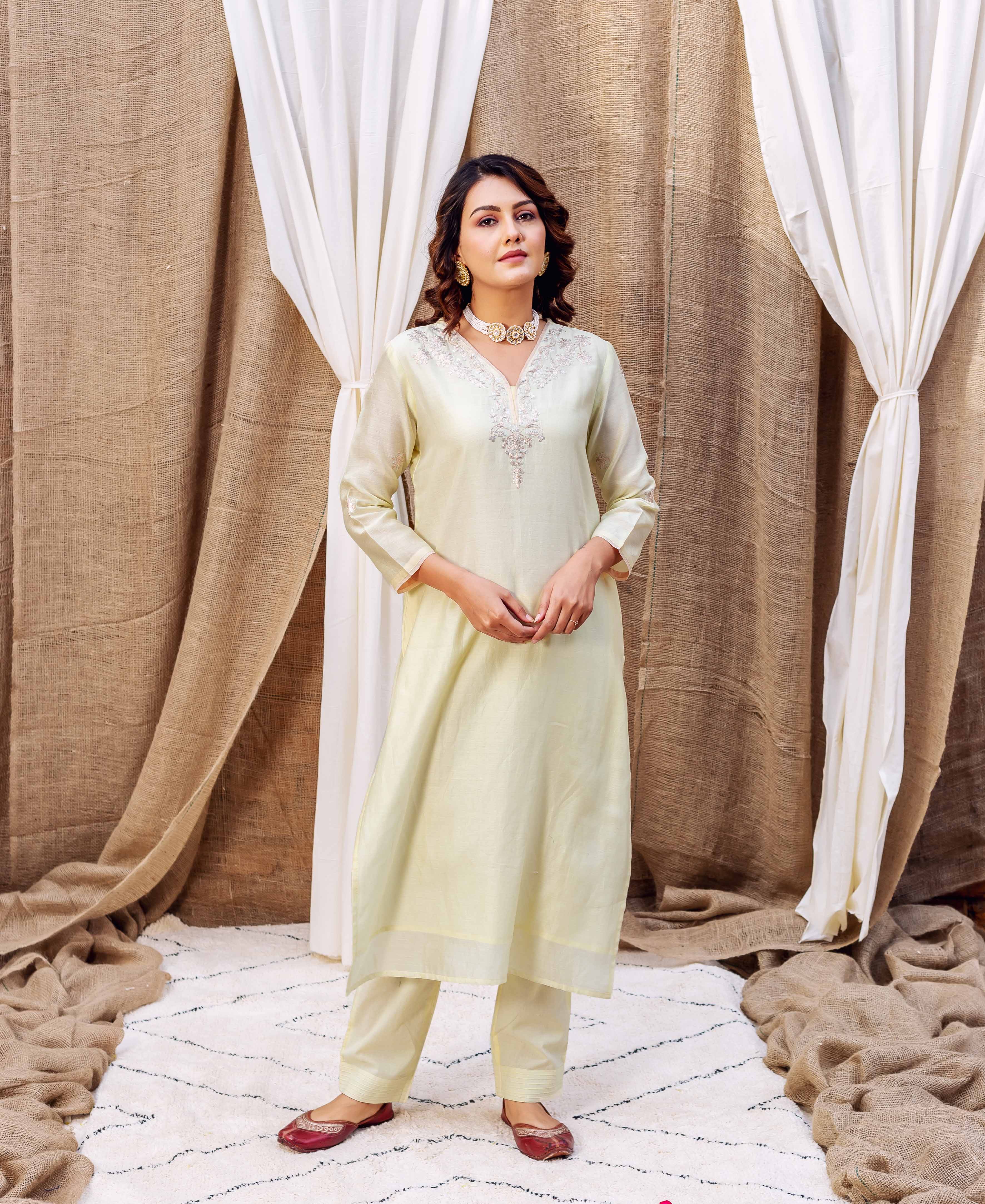 Model in Yellow Radiance kurta set with intricate pittan work embroidery on neckline.