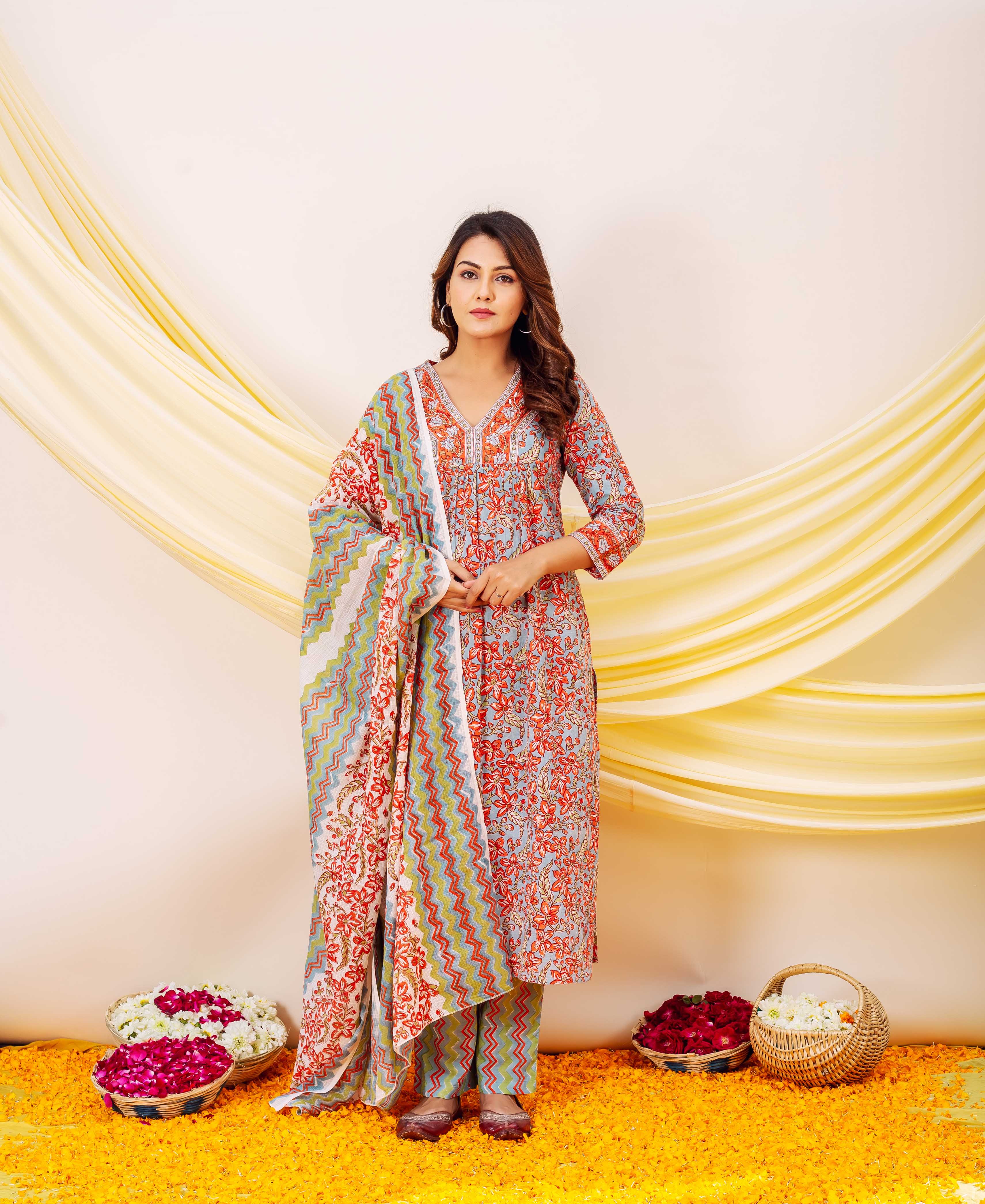 Model in light blue floral block print kurta, chevron pants, and dupatta.