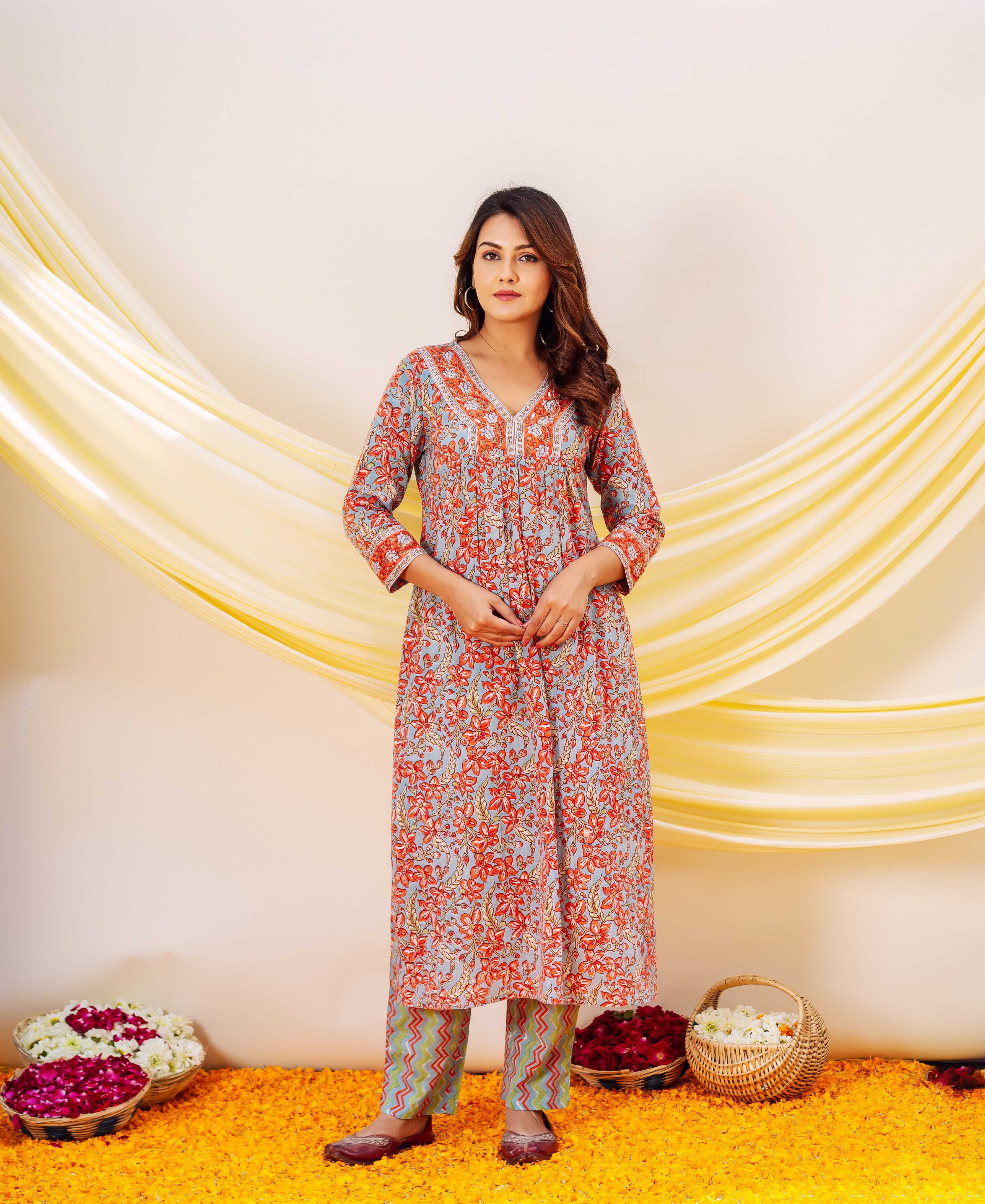 Front full-length shot of model in blue and red floral hand block printed kurta set.