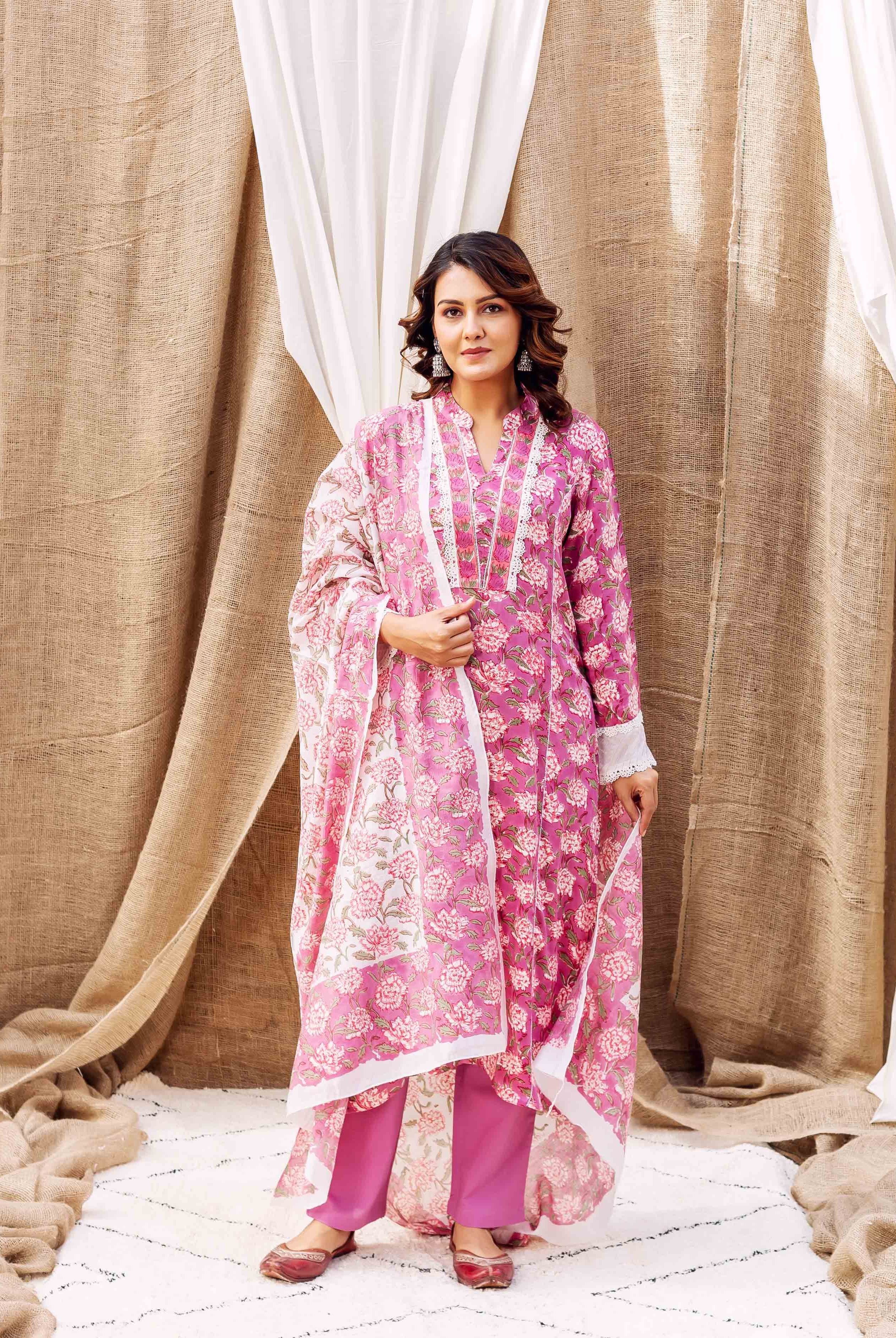 Vibrant pink floral hand-block-printed ethnic kurta set on a standing woman.