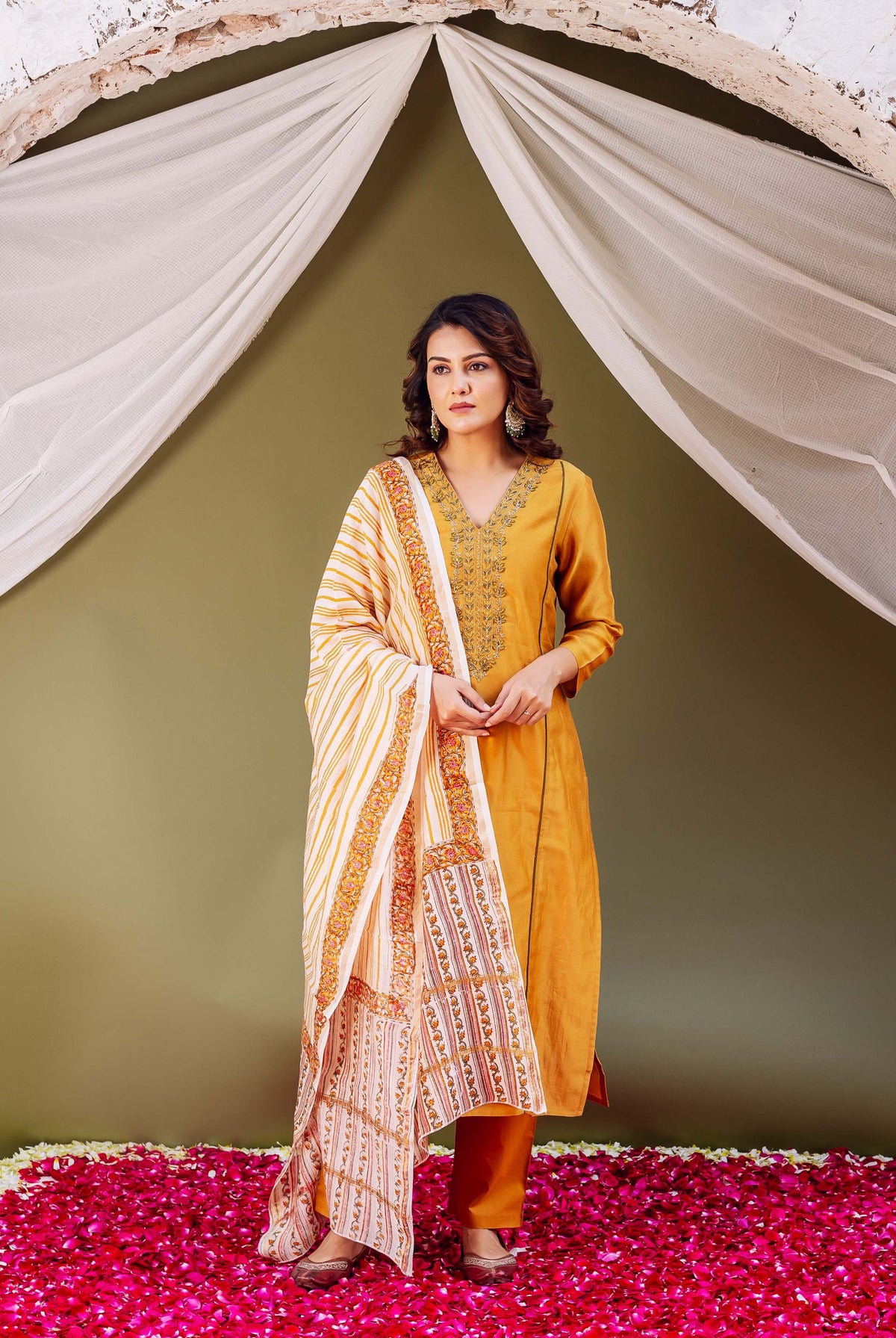 Full-length model in a mustard silk Chanderi kurta and striped hand-block-printed dupatta.