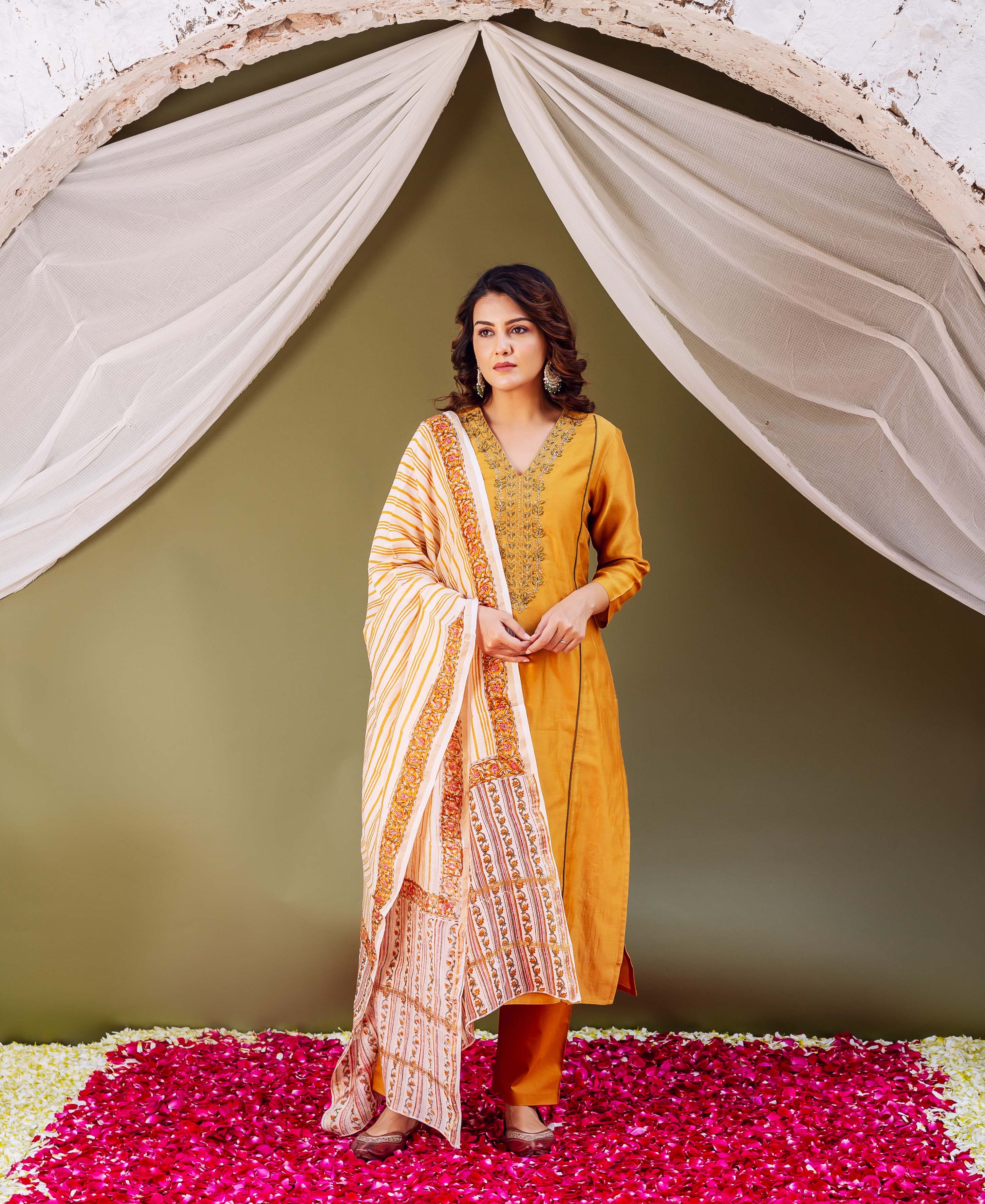 Model in elegant mustard kurta and pants with striped, intricate block-printed dupatta.