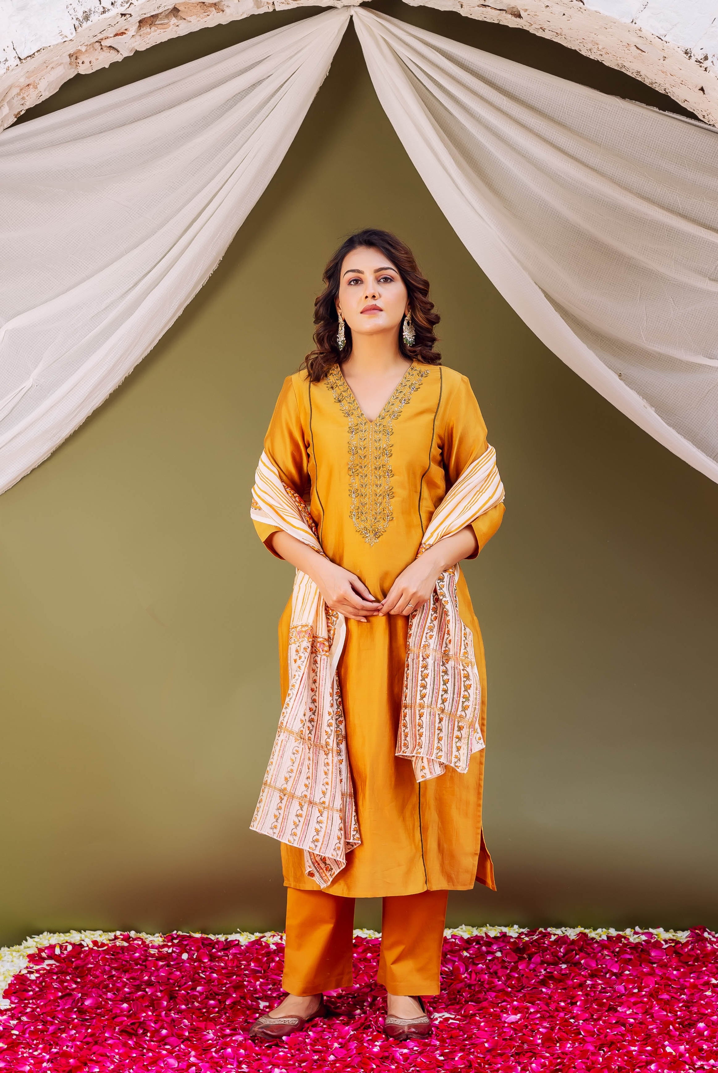 Model in a mustard ethnic silk kurta with embroidered V-neck and hand-block-printed dupatta.