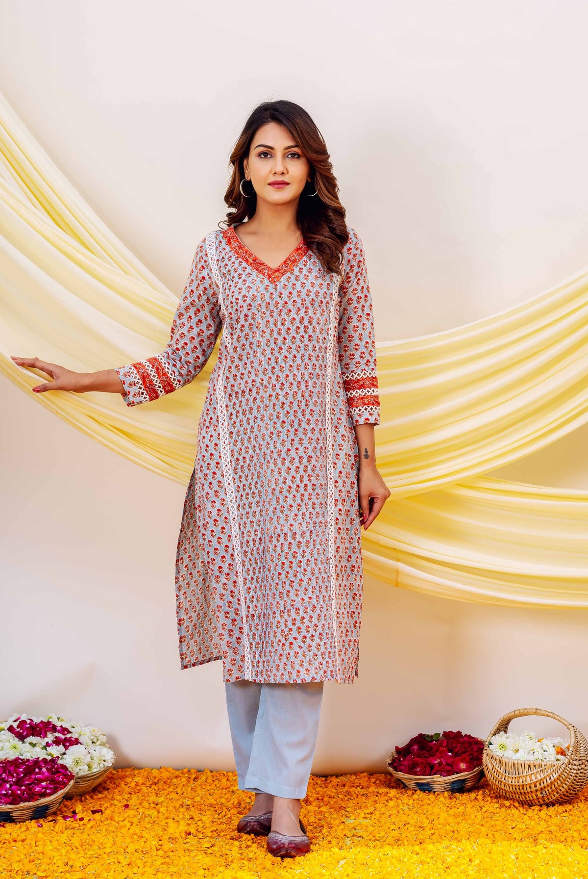 Front view model in light blue hand-block printed kurta with reddish-orange print, straight pants.