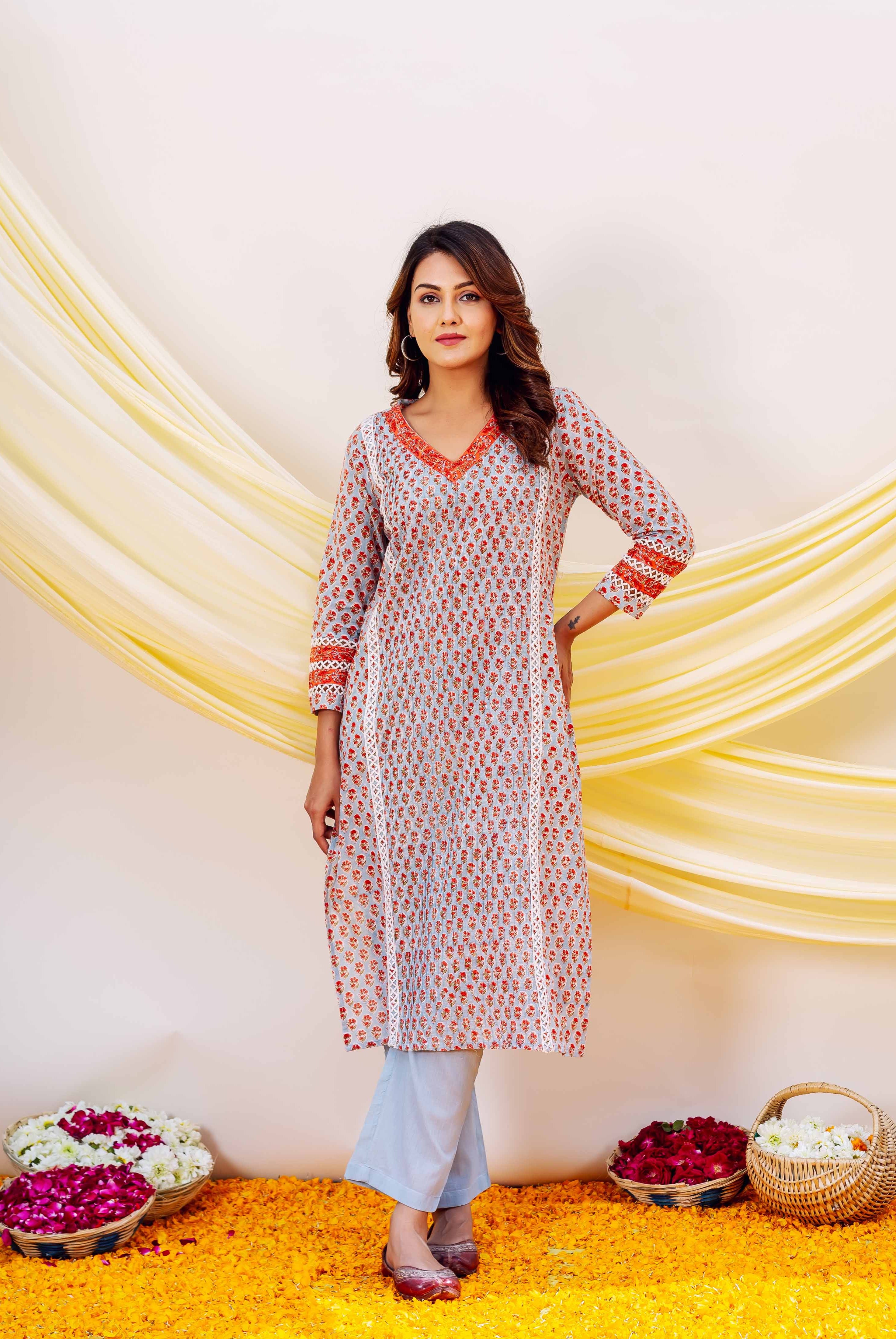 Front full look: model in light blue cotton hand-block print kurta with red floral motifs.