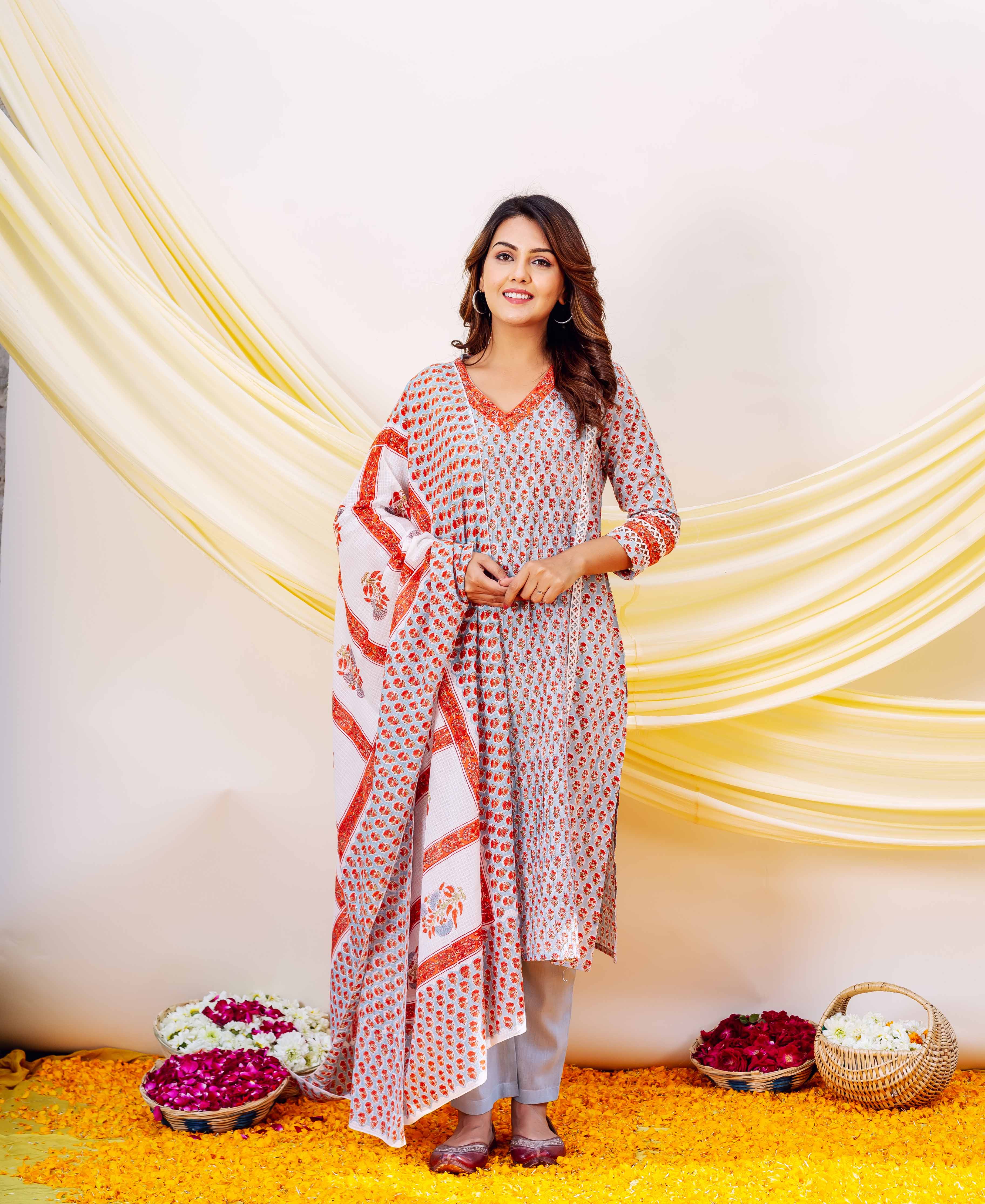 Woman in a printed kurta set with a white, red, and blue block print dupatta.