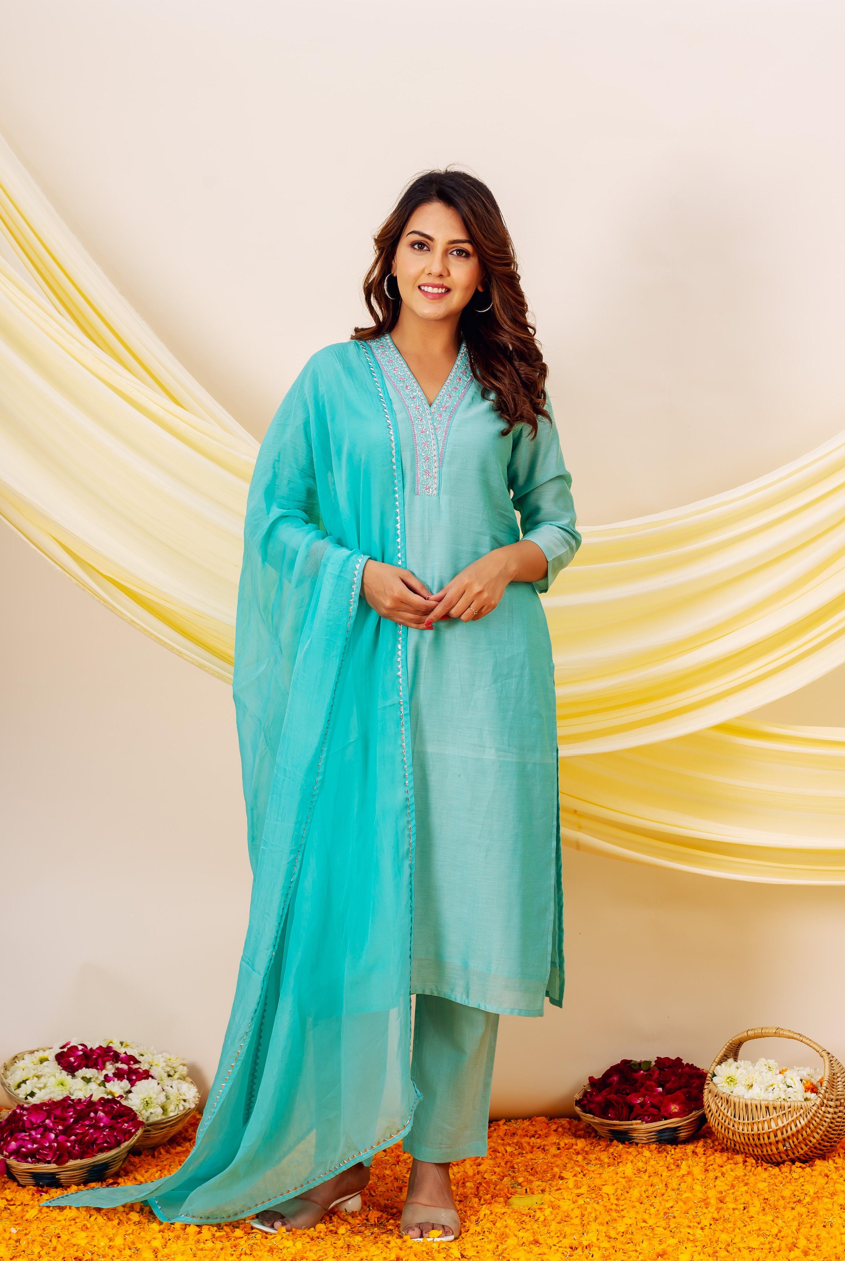 Turquoise Chanderi silk kurta with embroidered neckline and white accents on pale blue dupatta.