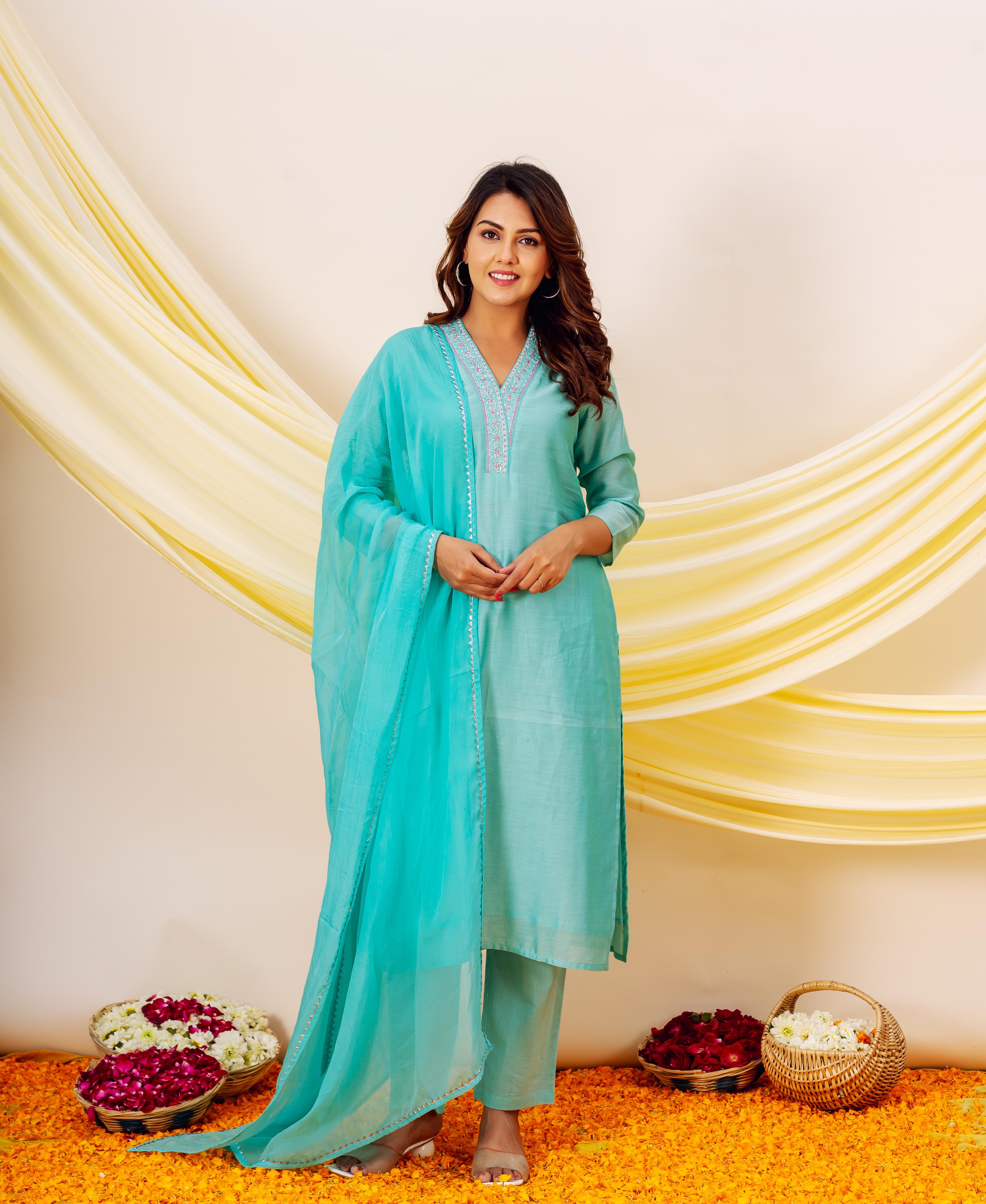 Turquoise Chanderi silk kurta with embroidered neckline and white accents on pale blue dupatta.