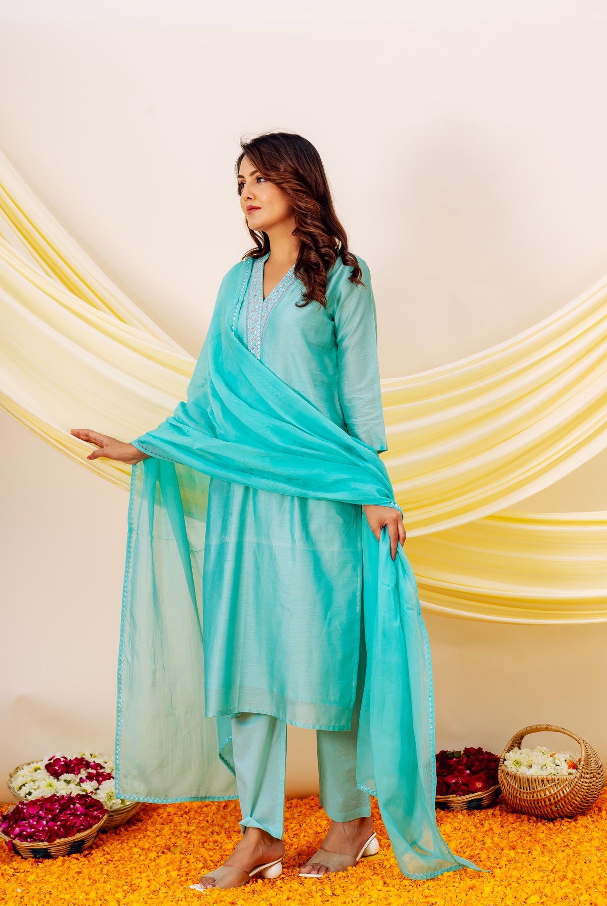 Model wearing aqua Chanderi silk kurta with embroidered V-neck, matching pants and dupatta.