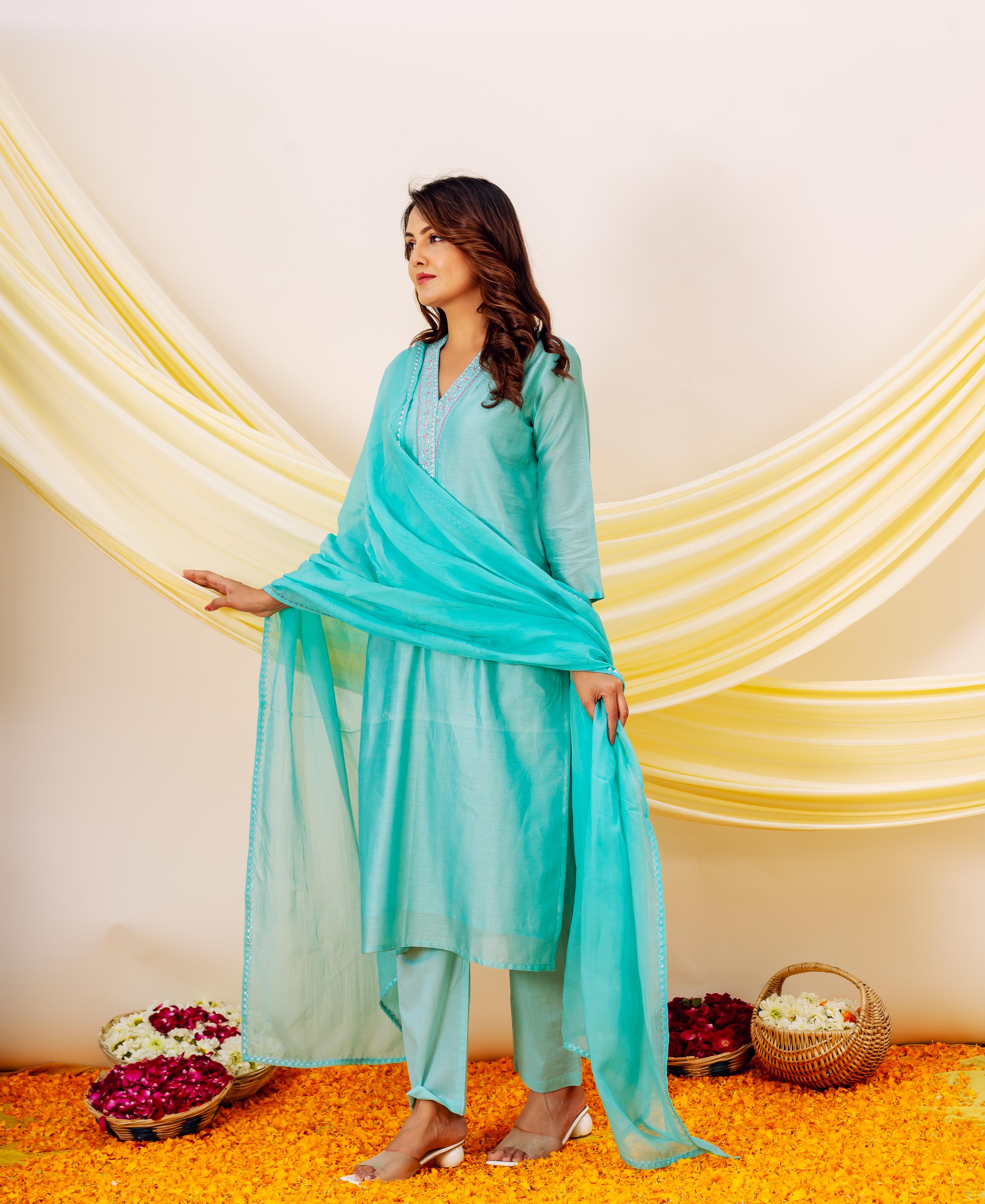 Model wearing aqua Chanderi silk kurta with embroidered V-neck, matching pants and dupatta.