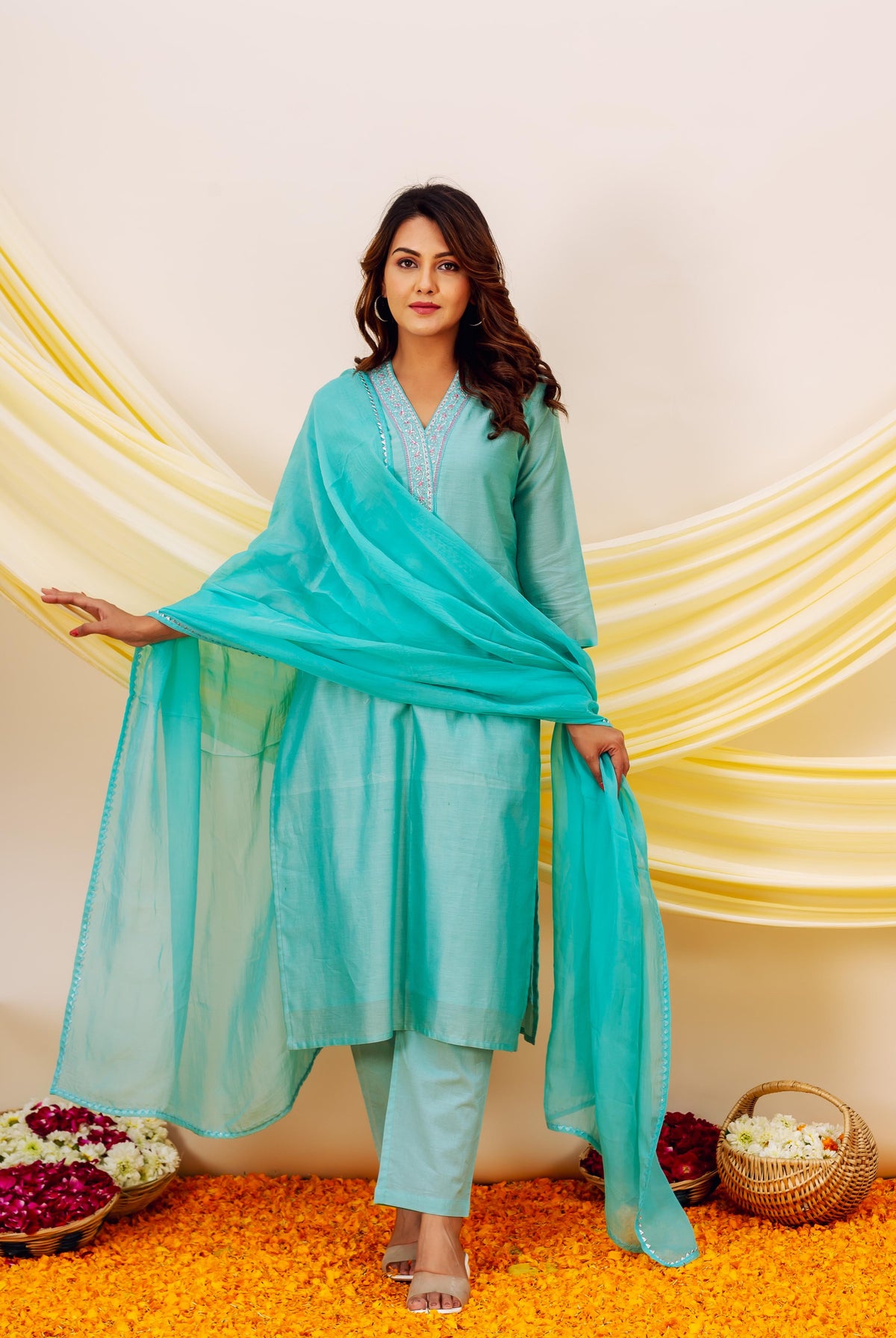 Turquoise kurta and pants with intricate neck embroidery and sheer dupatta on a model.
