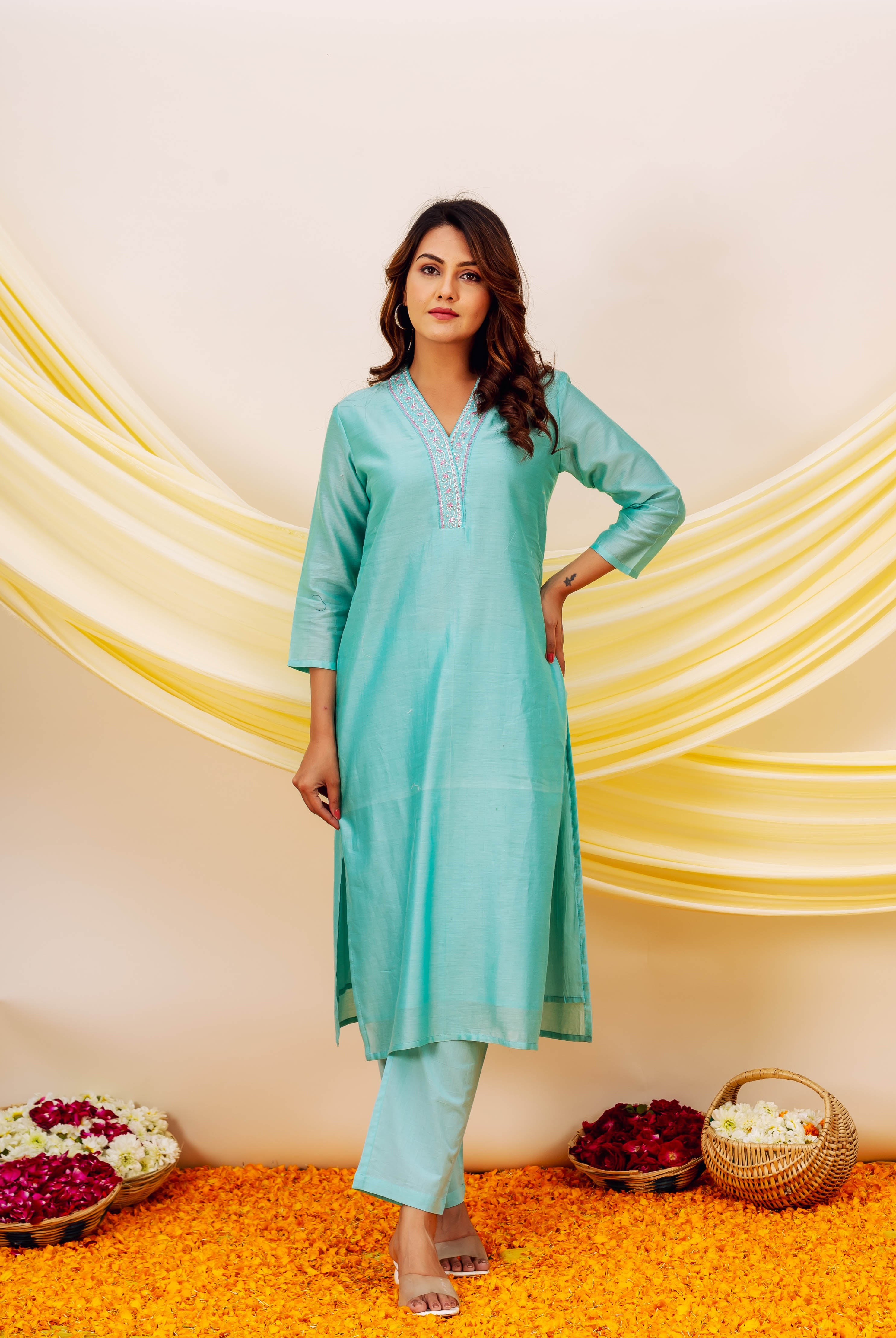 Model wears full aqua kurta set with delicate embroidered V-neckline.