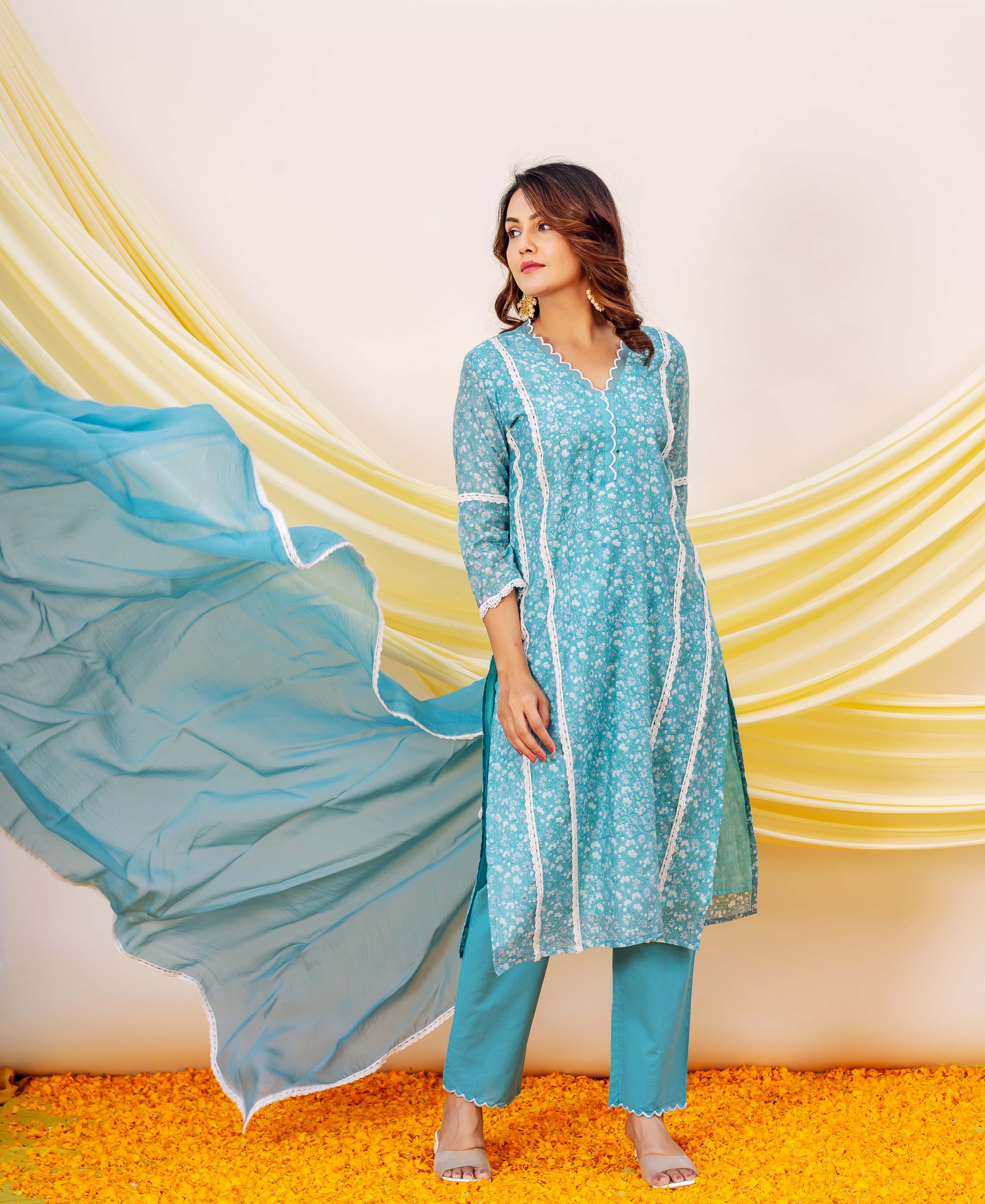 Front view of model in blue floral hand-block-printed kurta set with flowing dupatta.