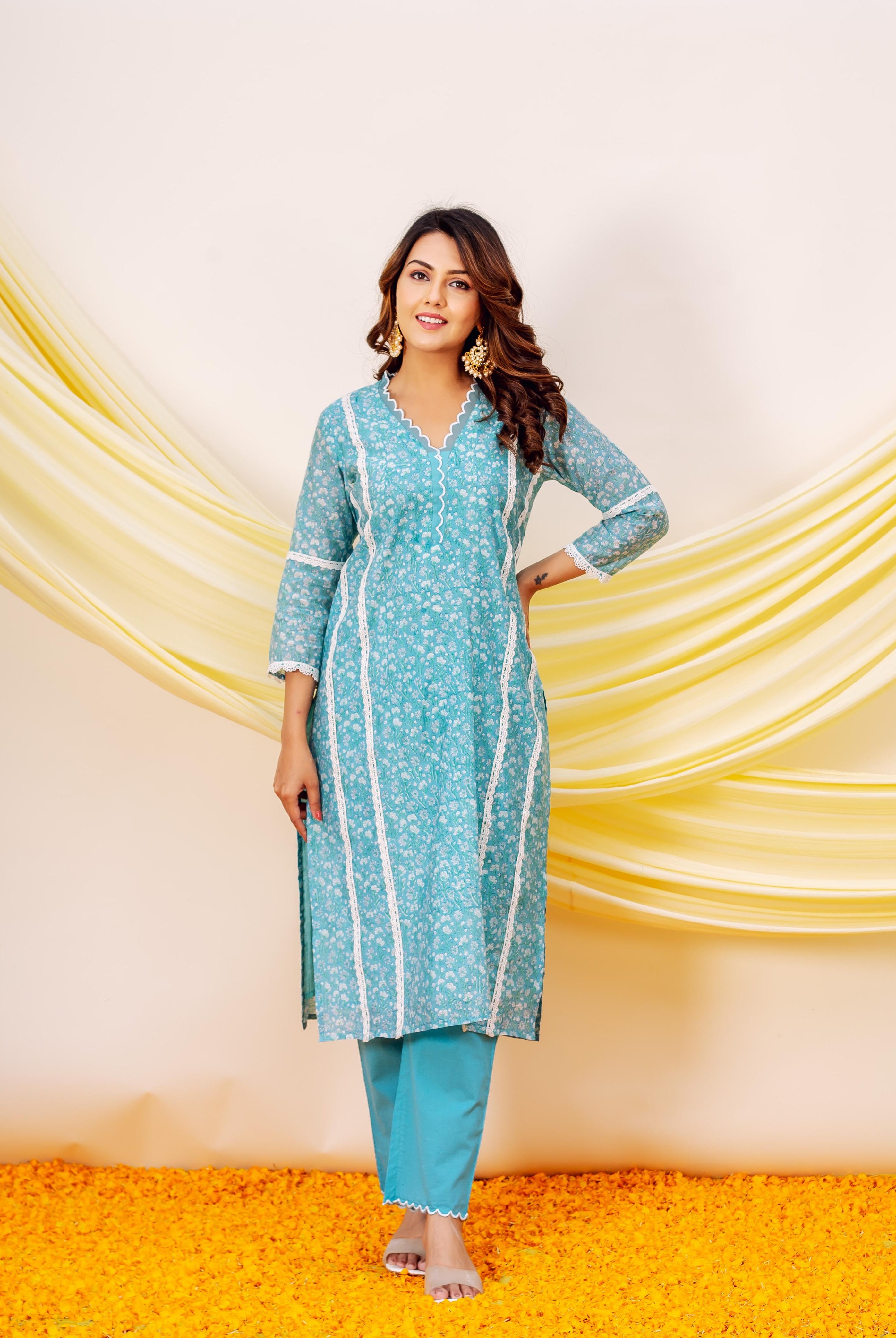 Front view model in a teal blue floral kurta set with white lace detailing.