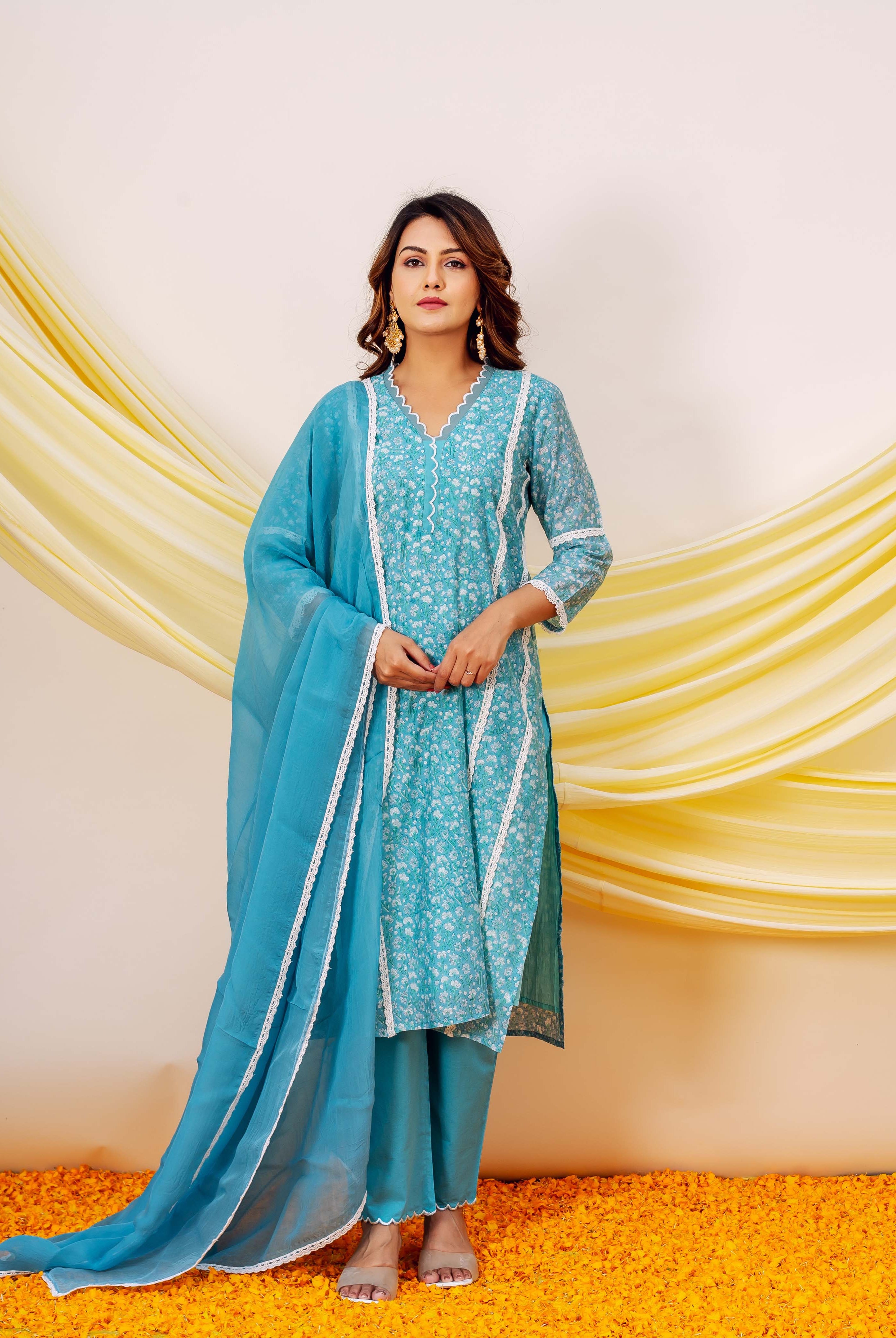 Model in a blue and white small floral hand-block printed kurta set with dupatta.