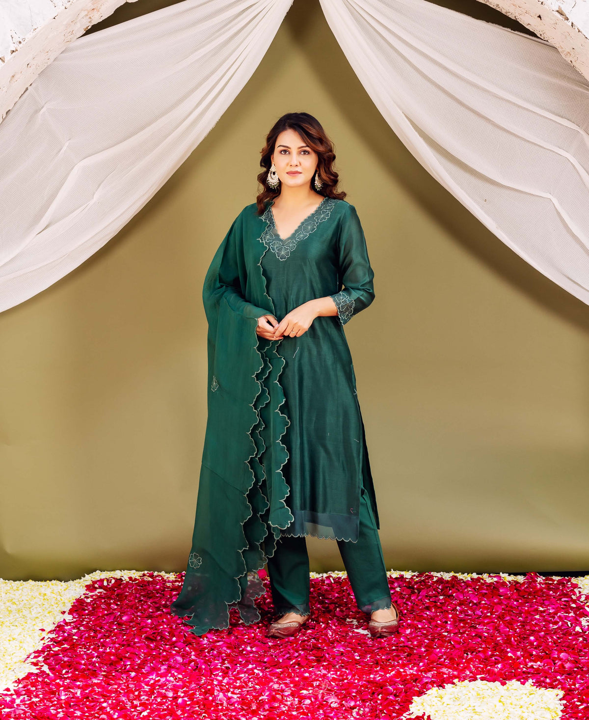 Full-length model in forest green silk Chanderi ensemble with delicate white printed scalloped trim.