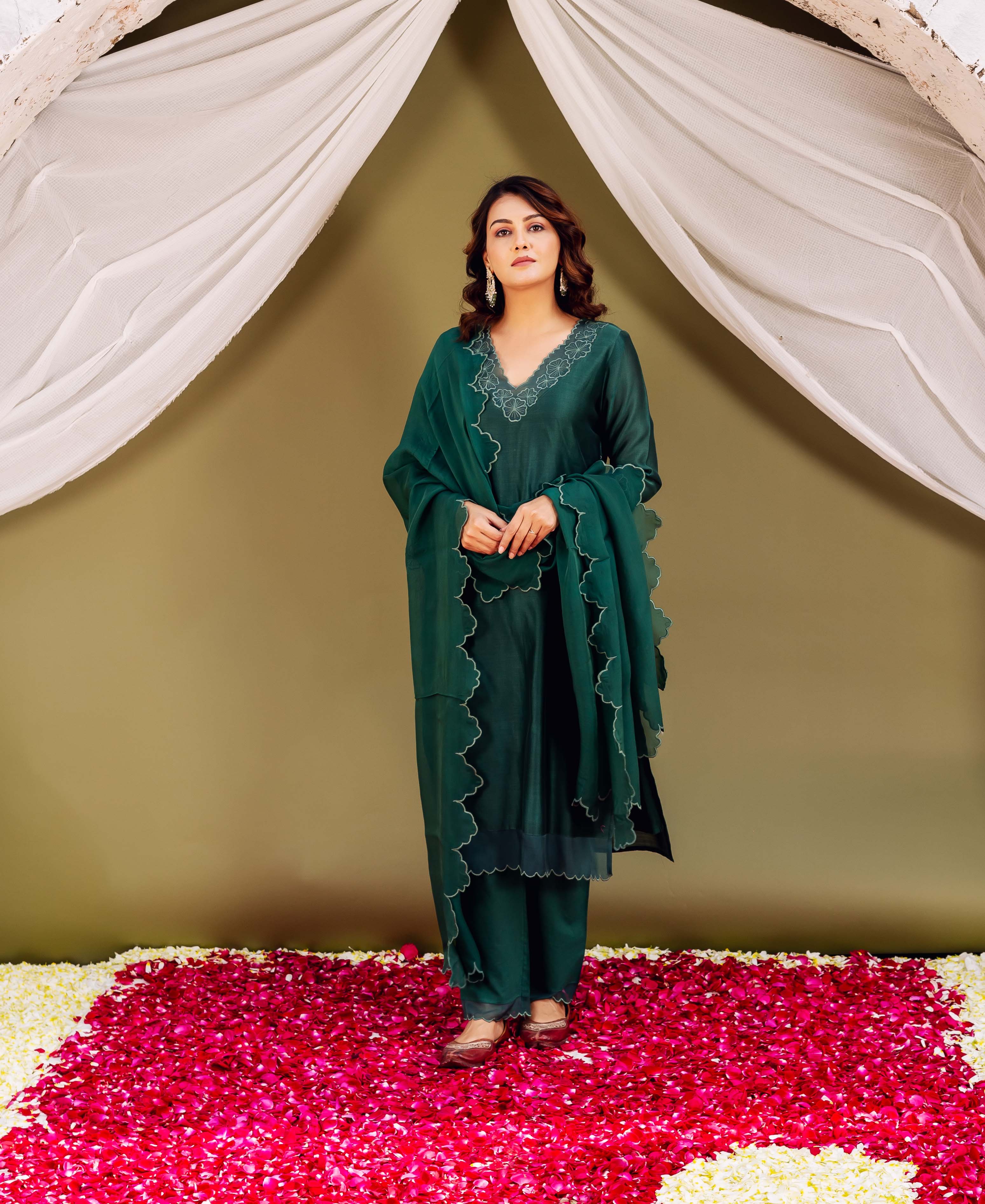 Full-length model in forest green silk chanderi ensemble with scalloped embroidered neckline and dupatta.