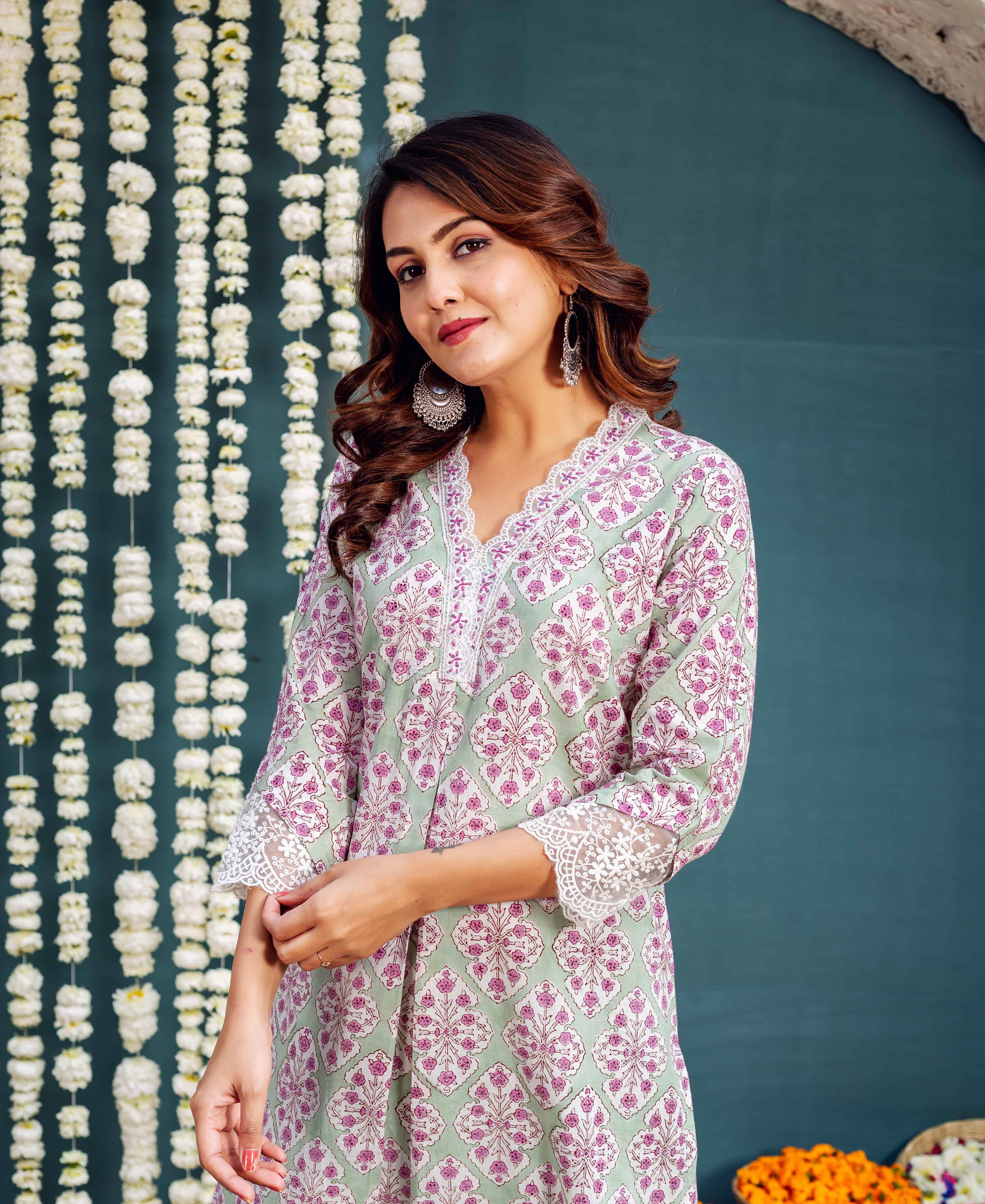 Model in a pale green block-printed kurta featuring magenta floral motifs and white lace details.