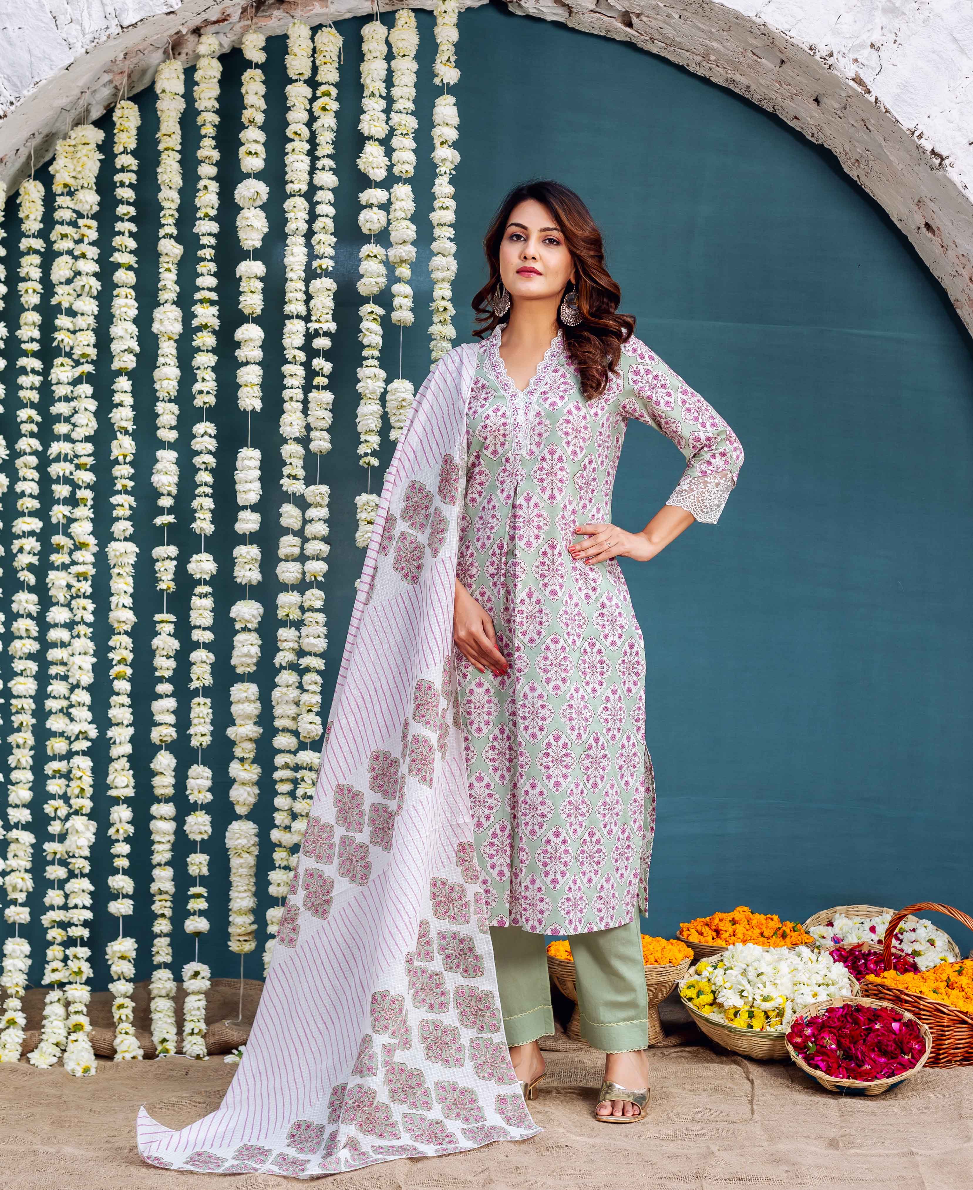 Standing woman models sage green hand-block printed kurta, olive pants, and patterned white dupatta.