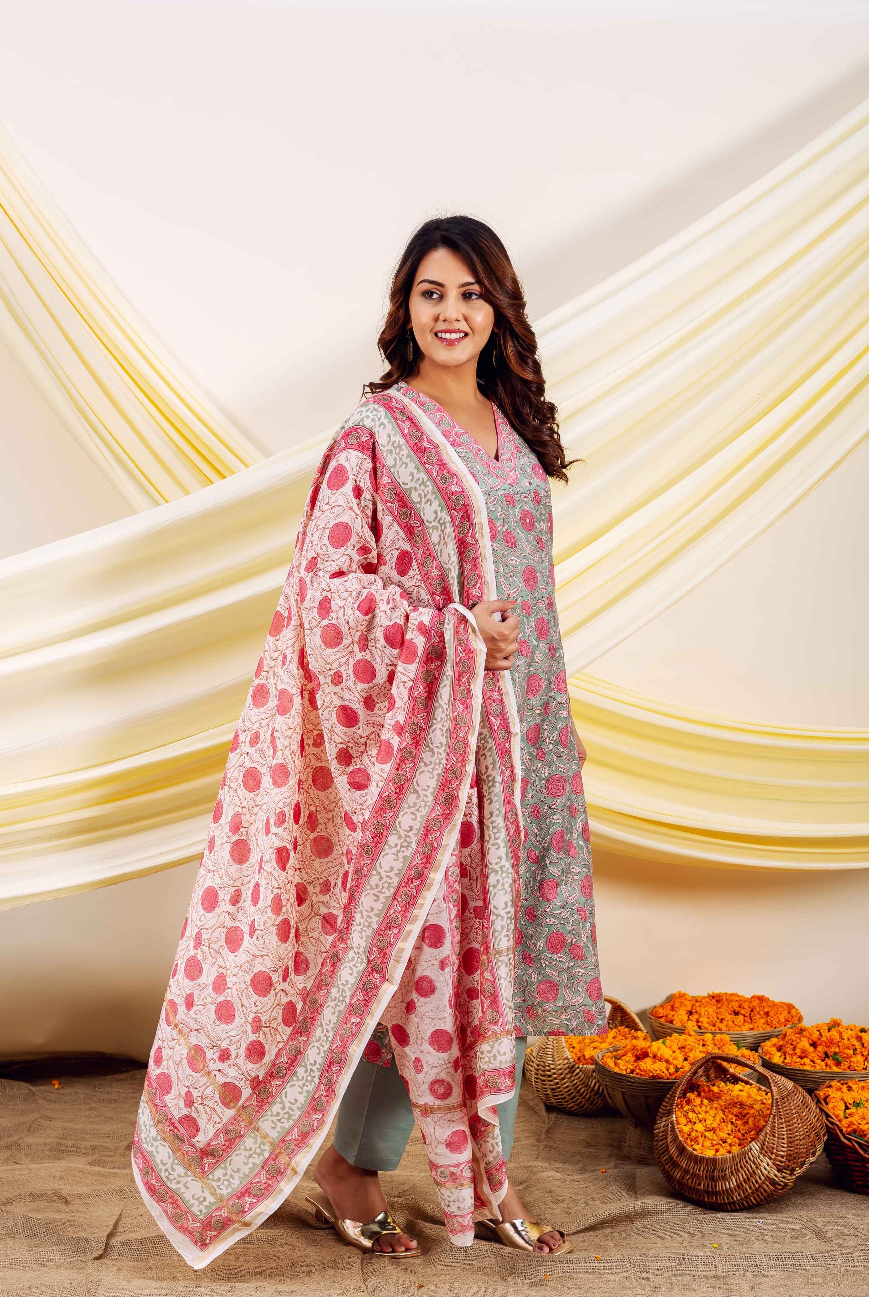 Woman modeling a serene grey-green and pink floral hand-block-printed ethnic ensemble.