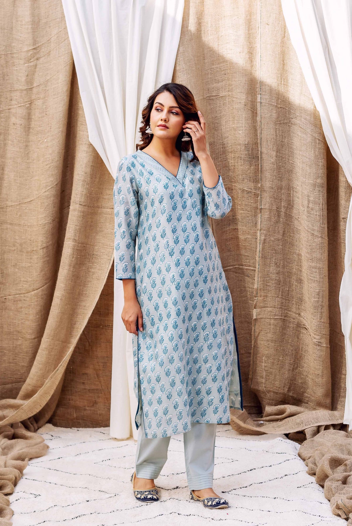 Woman wearing blue and white patterned slate silk chanderi silk kurta with matching trousers.