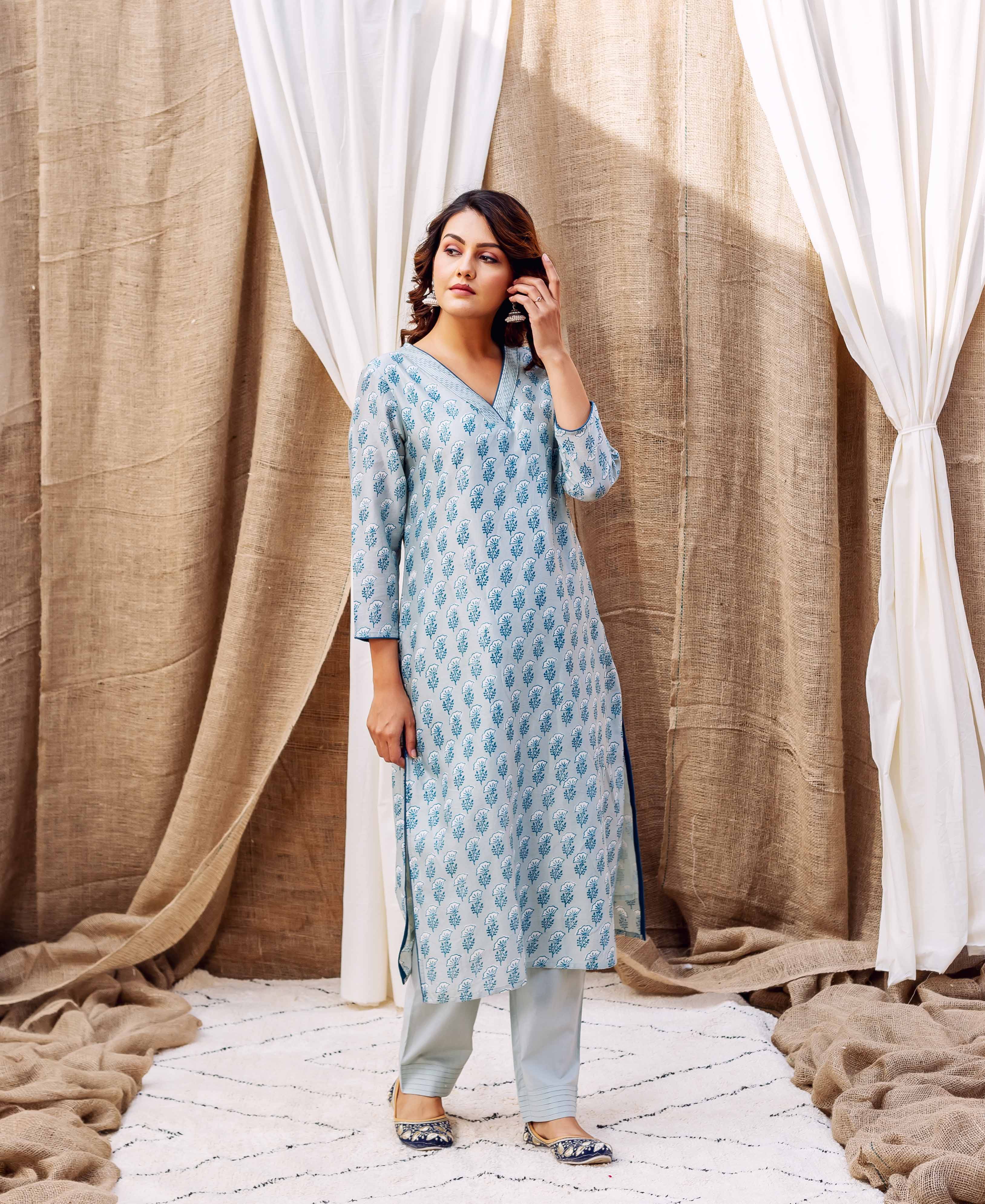 Woman wearing blue and white patterned slate silk chanderi silk kurta with matching trousers.