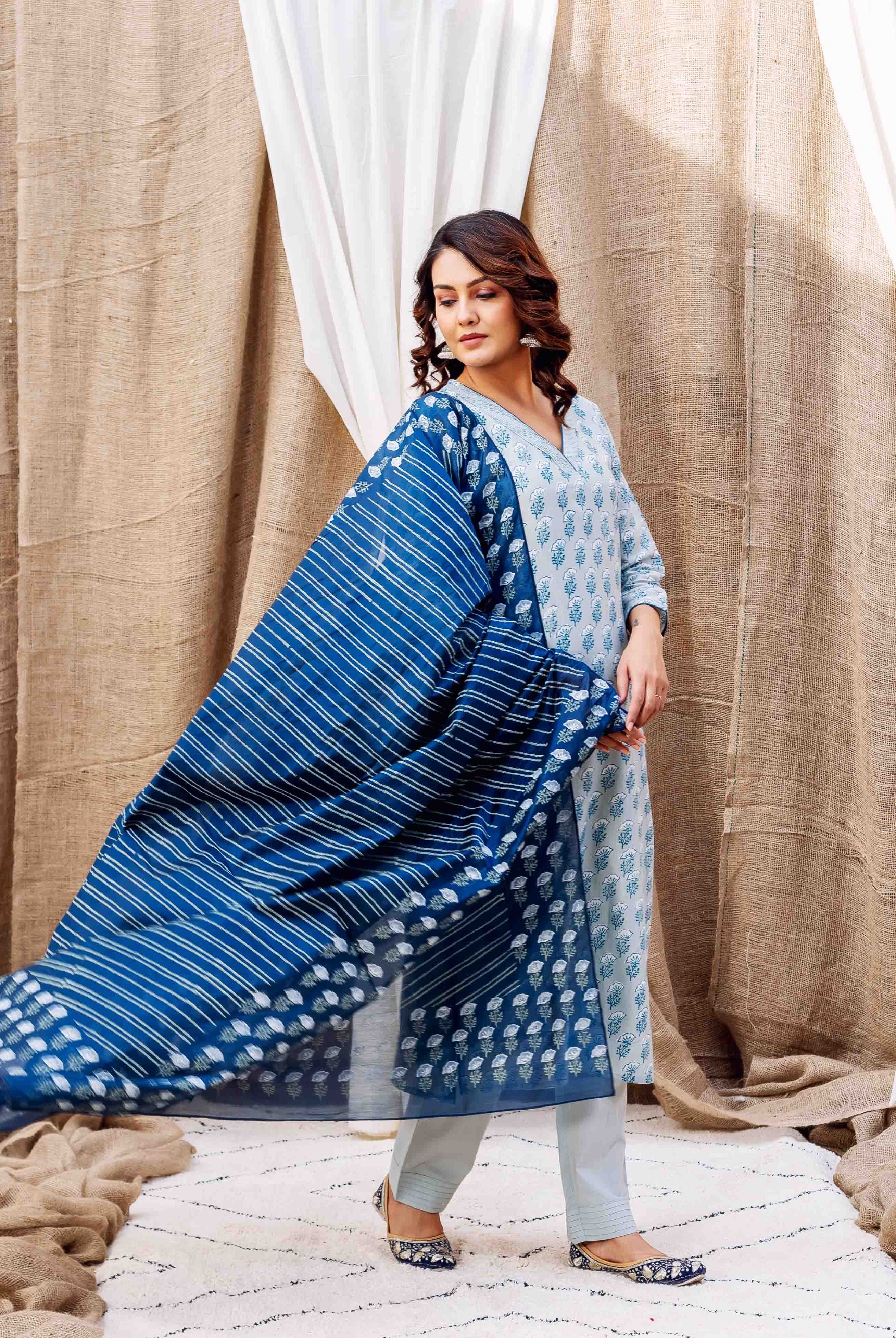 Model in a light blue block-printed kurta with a flowing dark blue striped dupatta, standing.