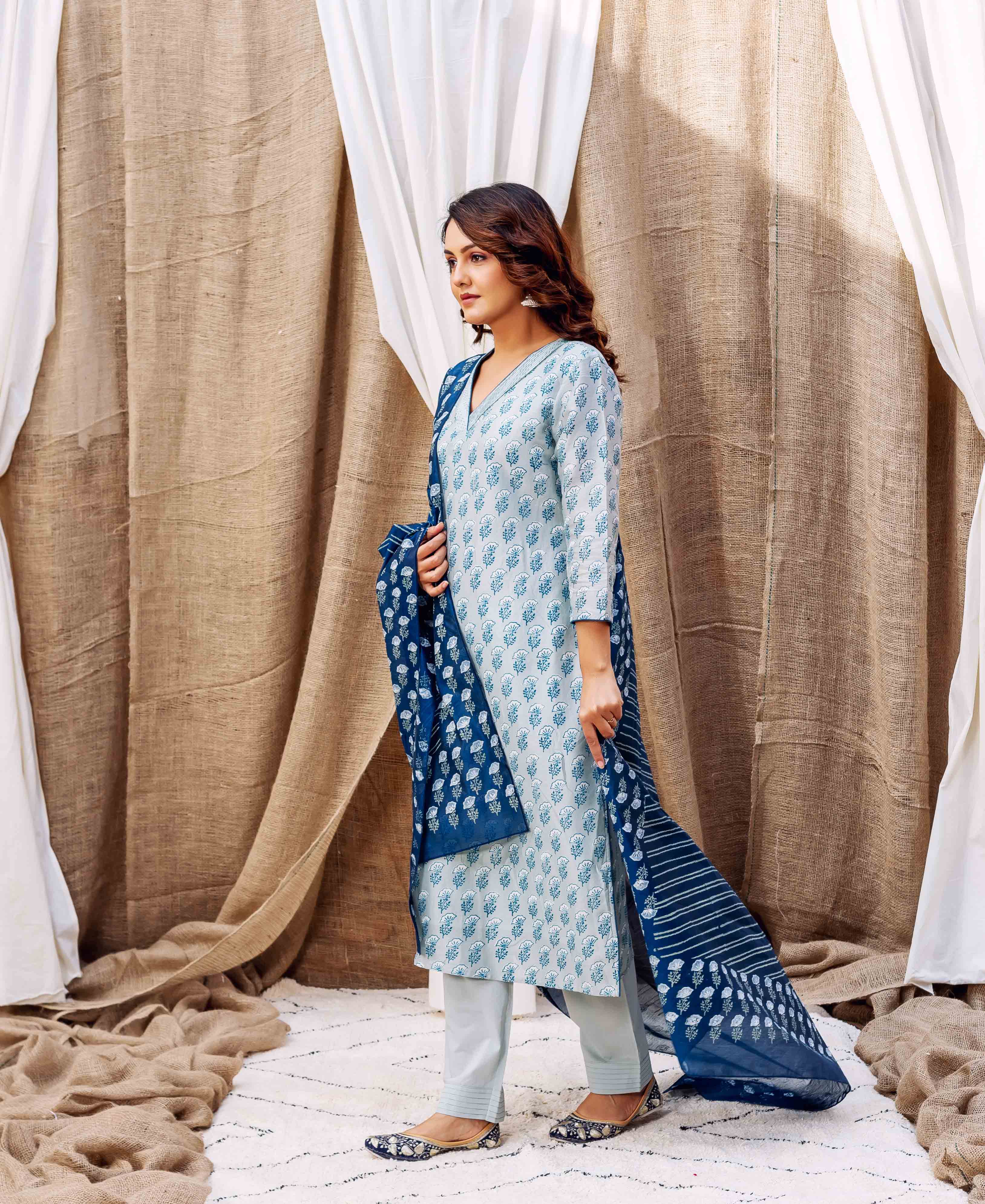 Model in slate hand-block-printed kurta set featuring a leafy pattern and dark blue dupatta.