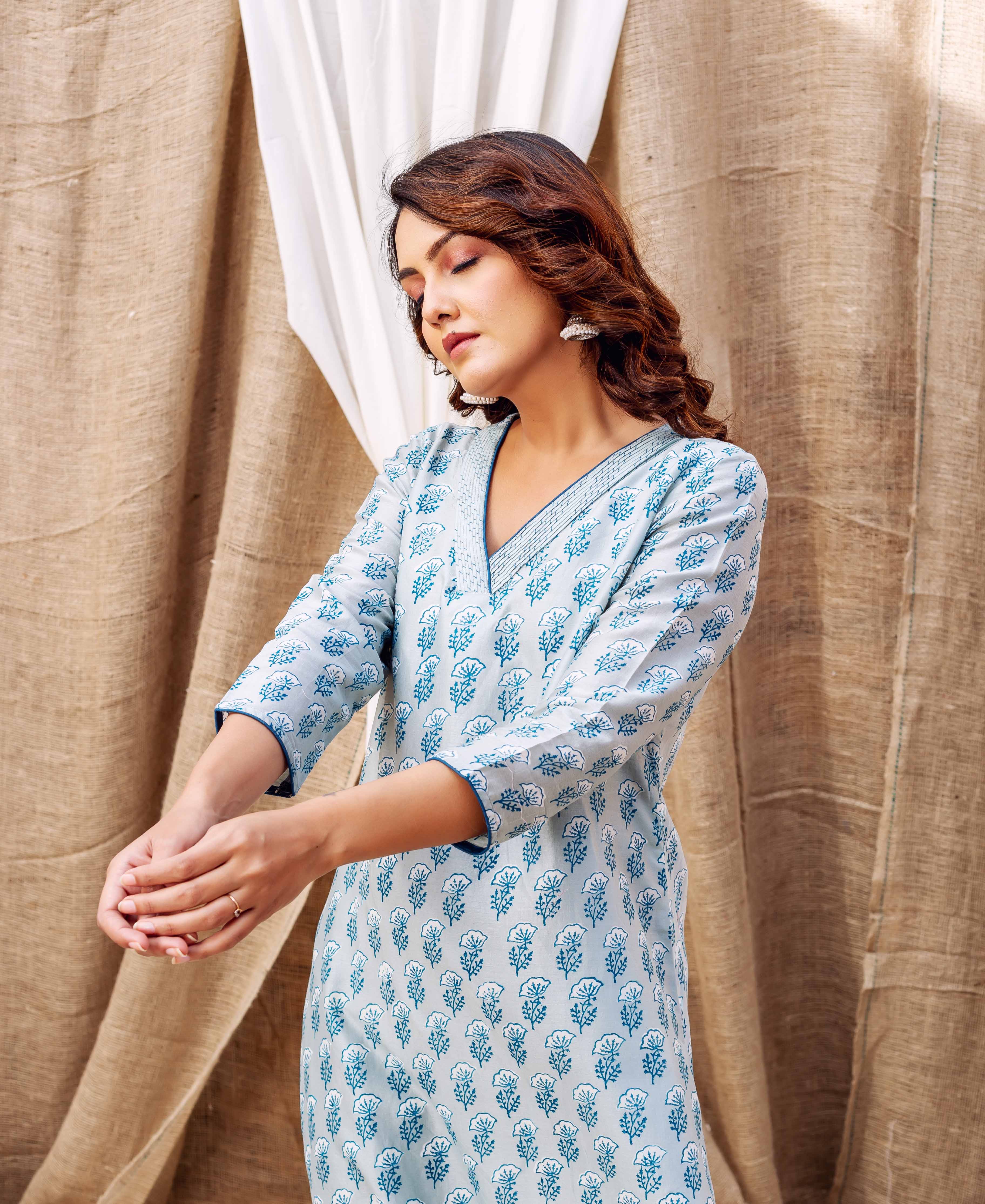Model wears slate blue hand-block-printed ethnic kurta with V-neck and three-quarter sleeves.