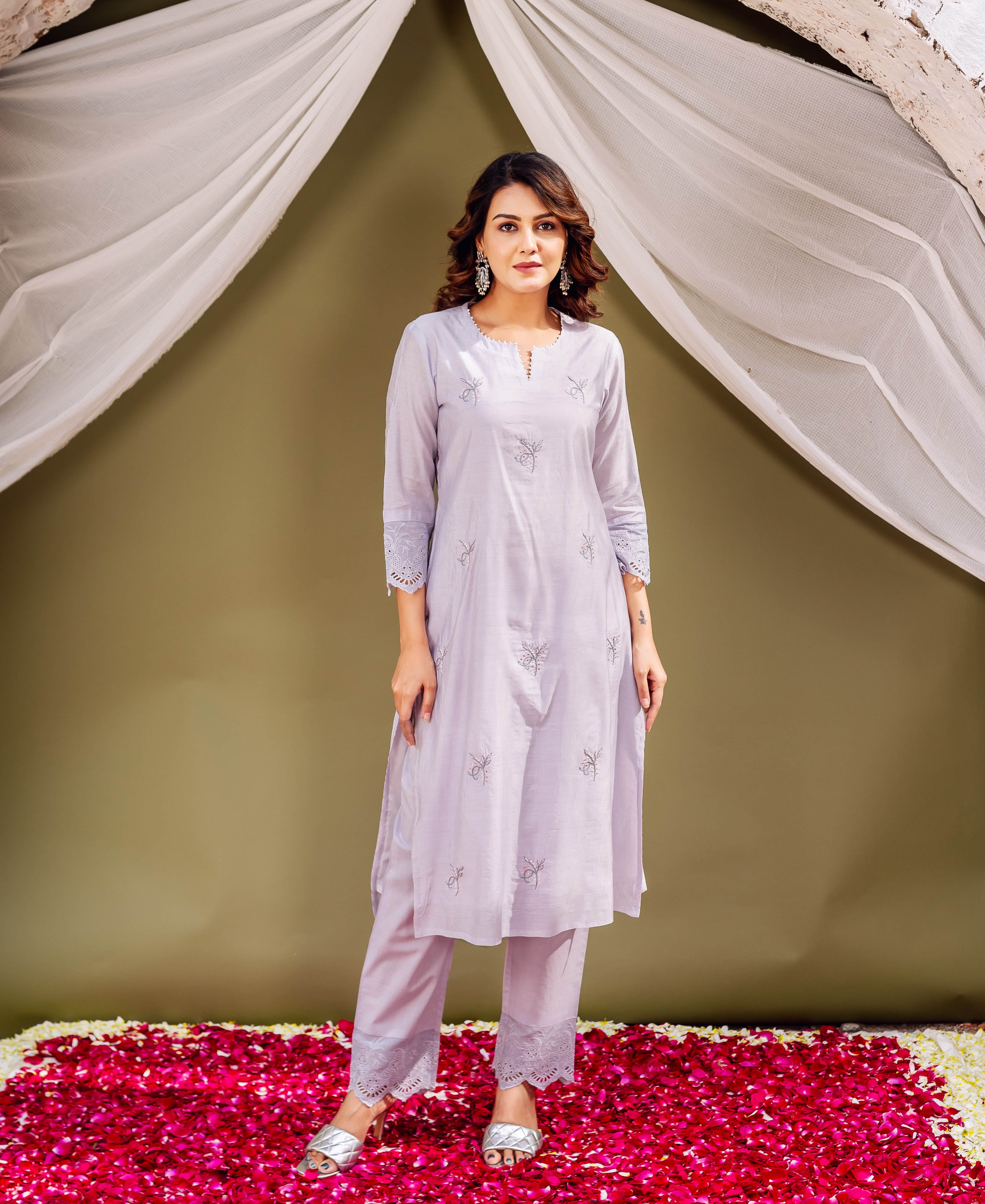 A model wearing a lavender kurta with floral prints and lace details.