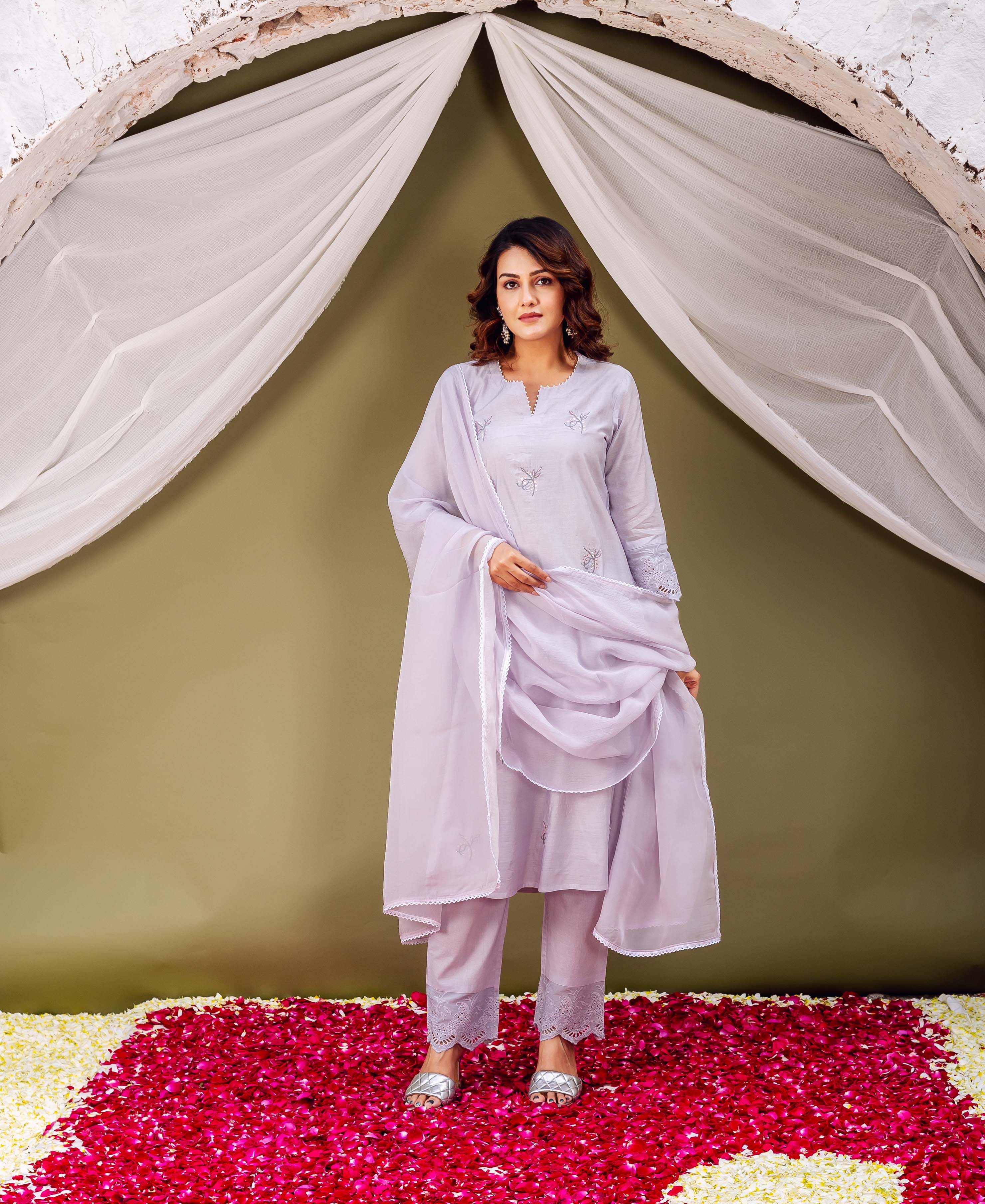 Model wears a lavender kurta set featuring subtle embroidered motifs and scalloped hems.