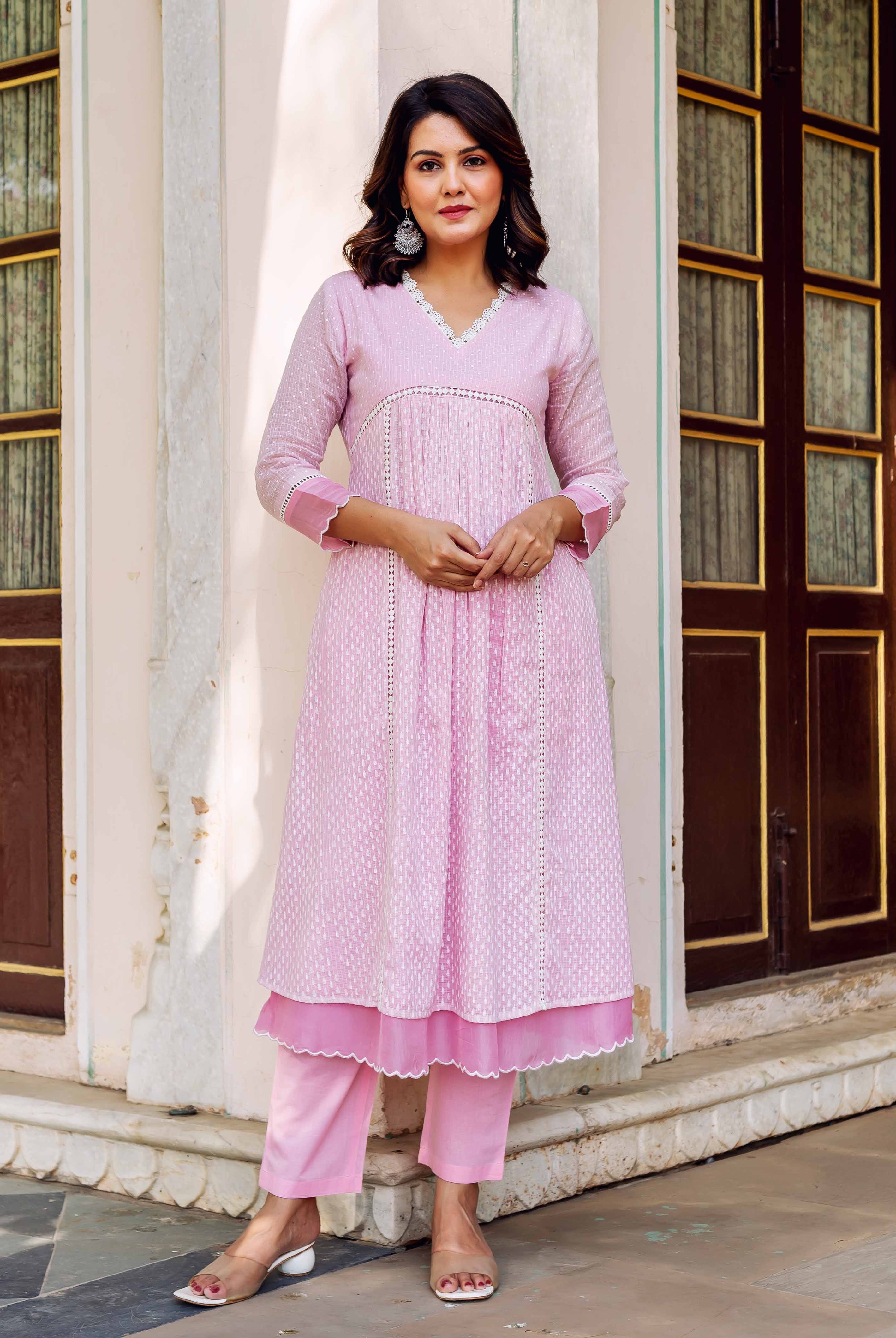 Model wearing a blush pink Kota Doria kurta set with white hand-block print.