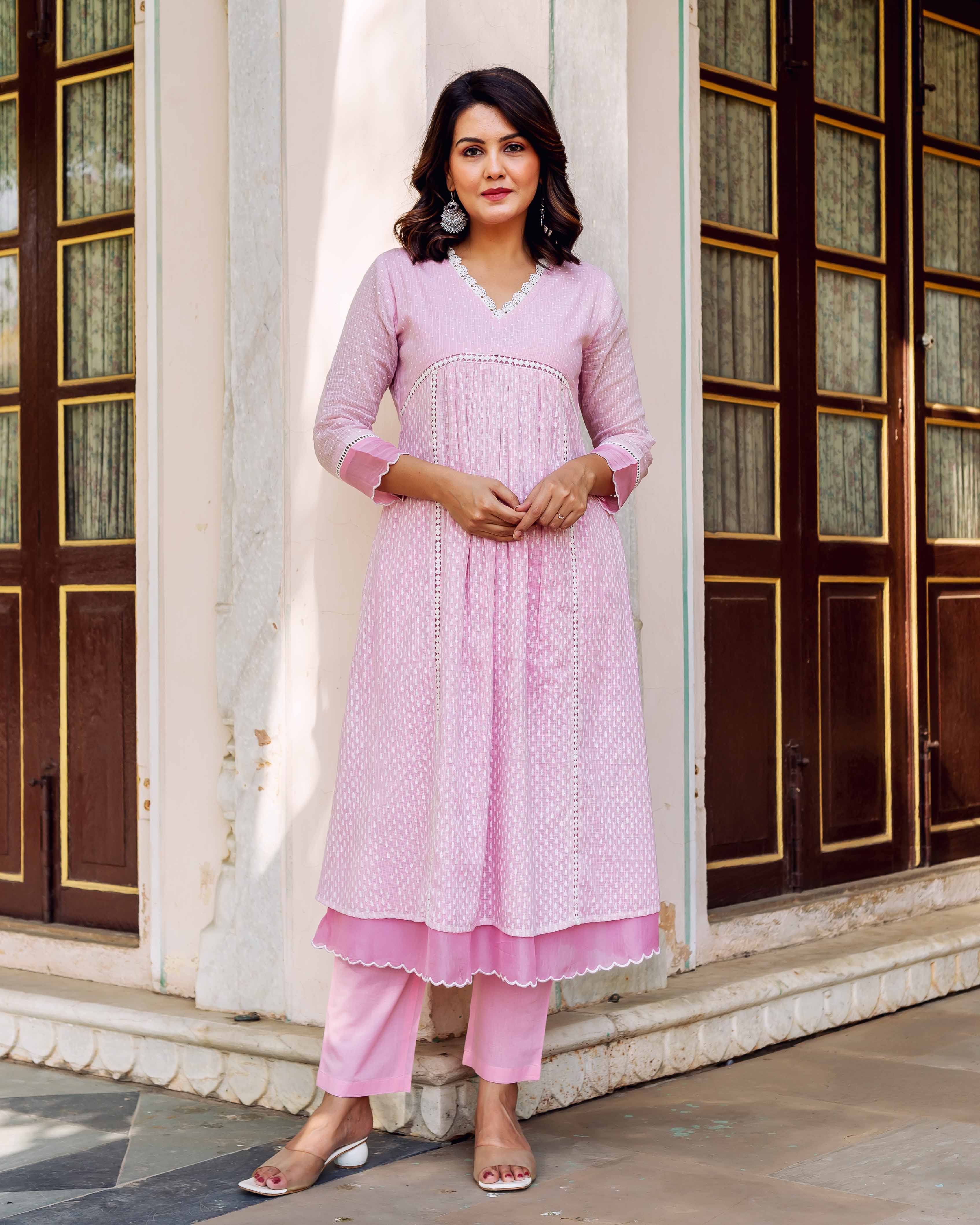 Model wearing a blush pink Kota Doria kurta set with white hand-block print.