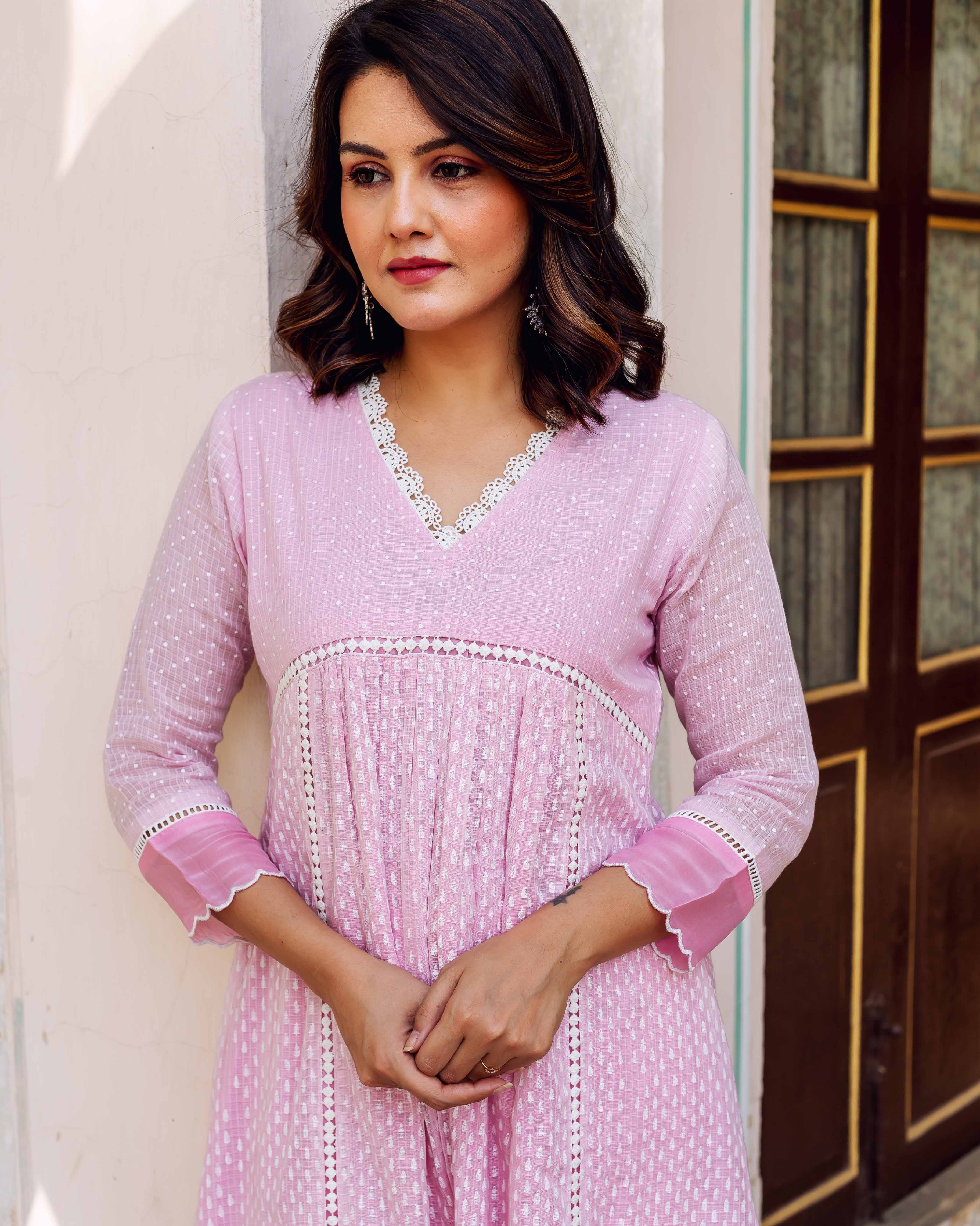 Blush pink Kota Doria kurta on a model, with white hand-block printed dots and lace.
