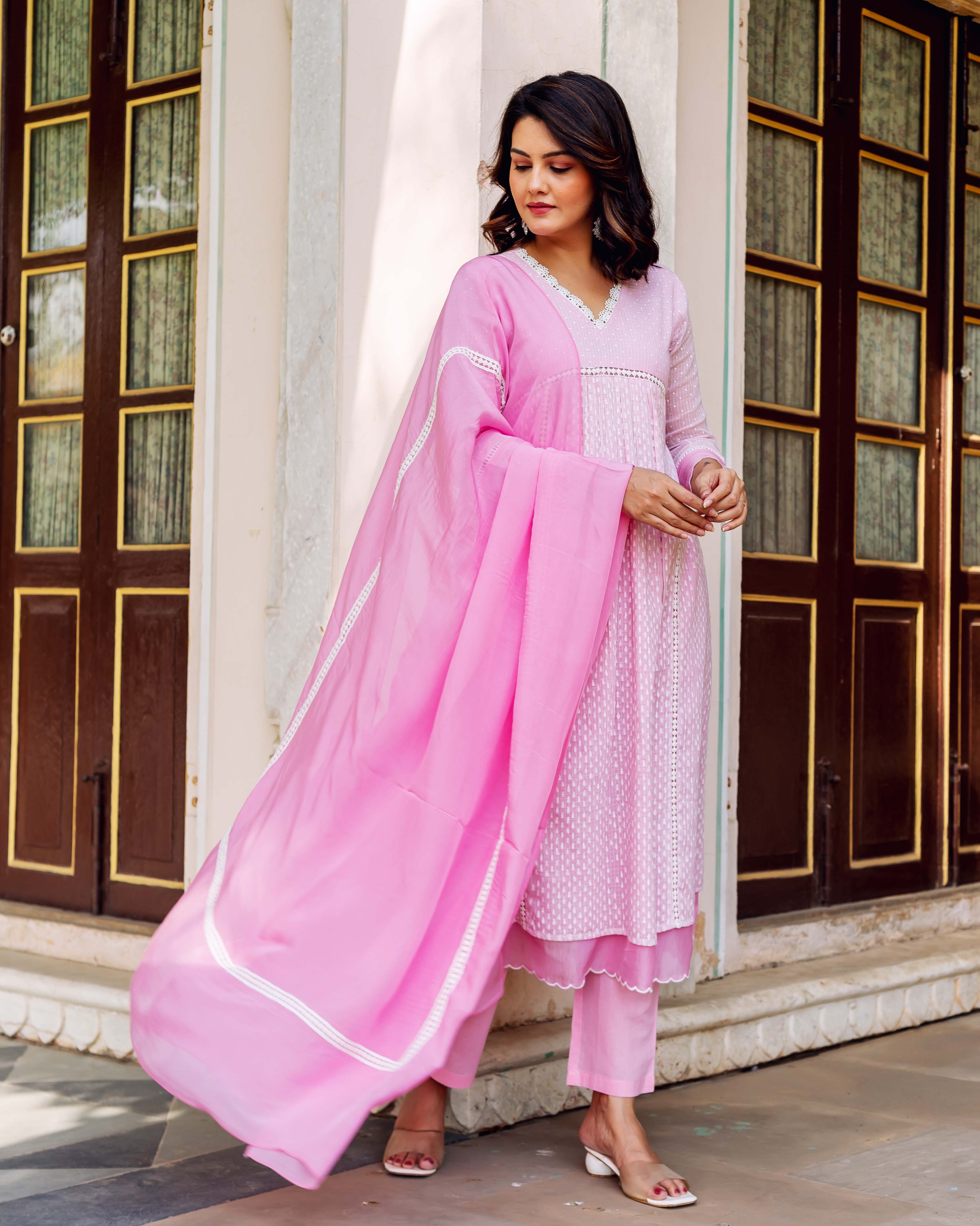 Blush pink V-neck hand-block-printed kurta set with flowing dupatta on model.
